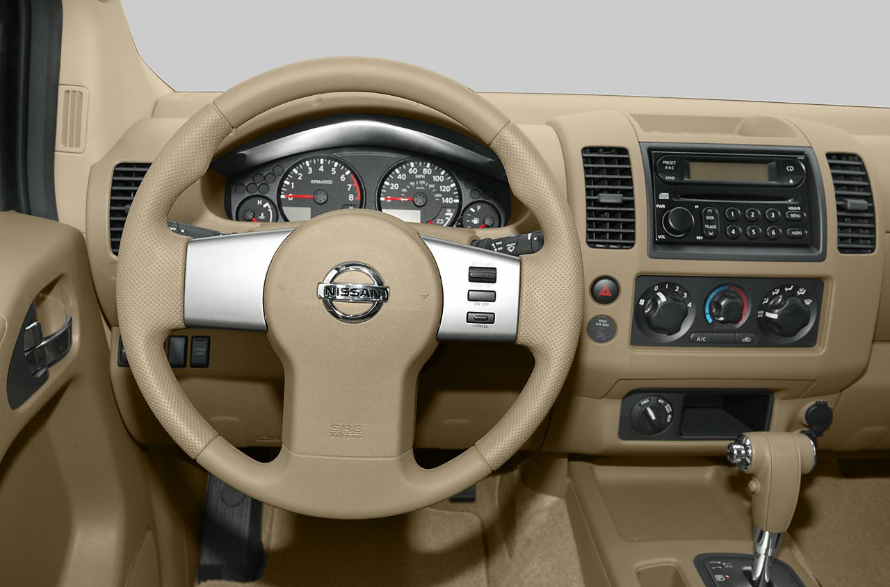 Beige interior dashboard and steering wheel with controls.