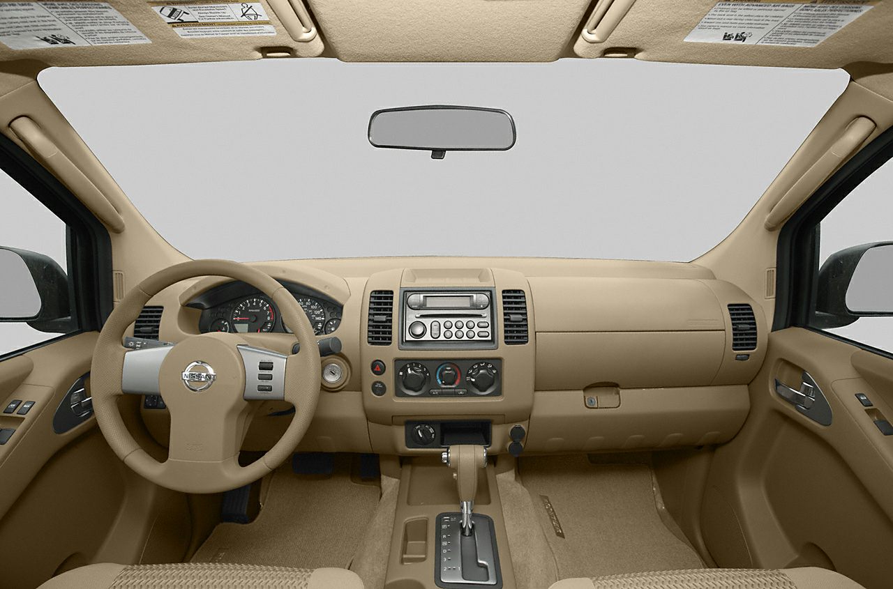 Beige dashboard and steering wheel interior with central console controls