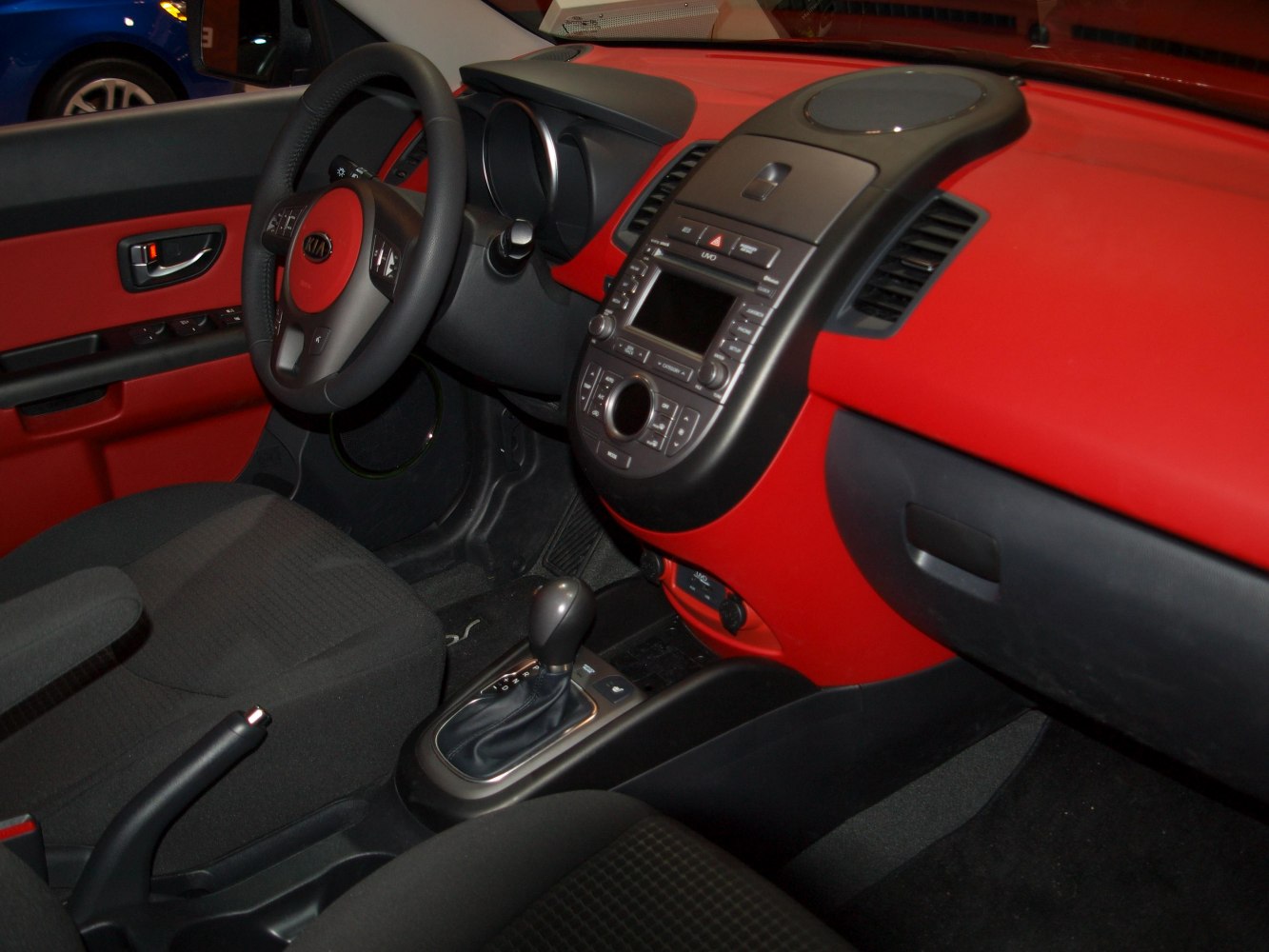 Red and black dashboard with central control panel and automatic gear shift
