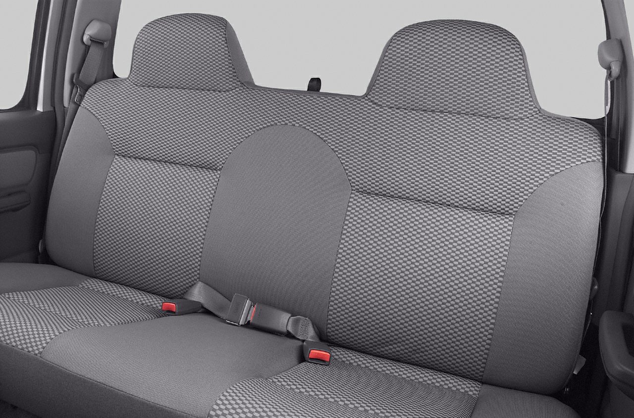 Rear seat upholstery with patterned fabric and integrated seatbelts.