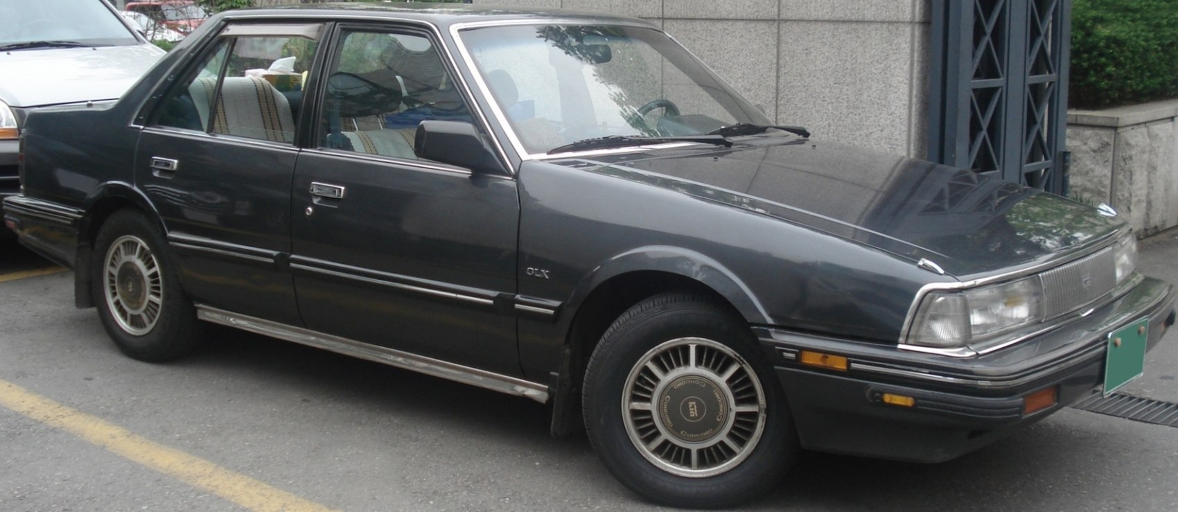 Classic sedan front side profile with boxy design and alloy wheels