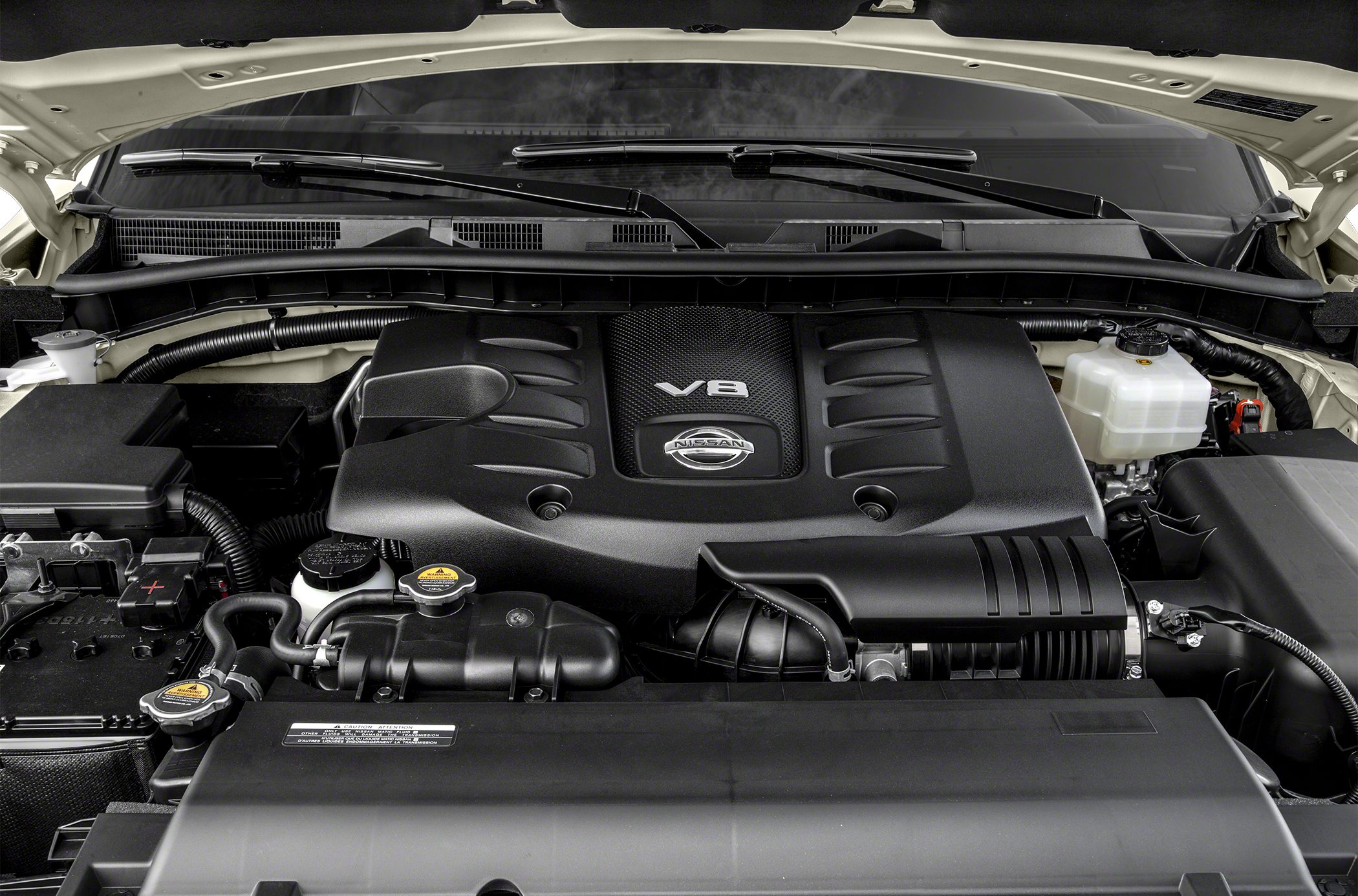 V8 engine bay with Nissan logo and components under hood