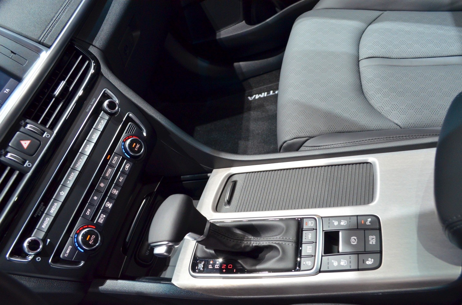 Car interior console with gear shifter and dual-zone climate control.