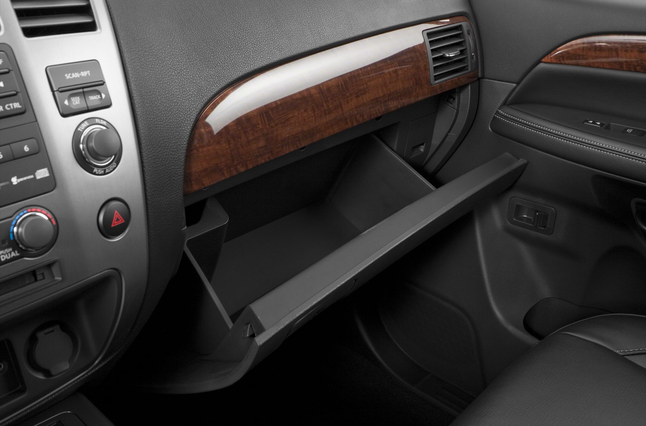 Open glove box and wood-trimmed dashboard panel