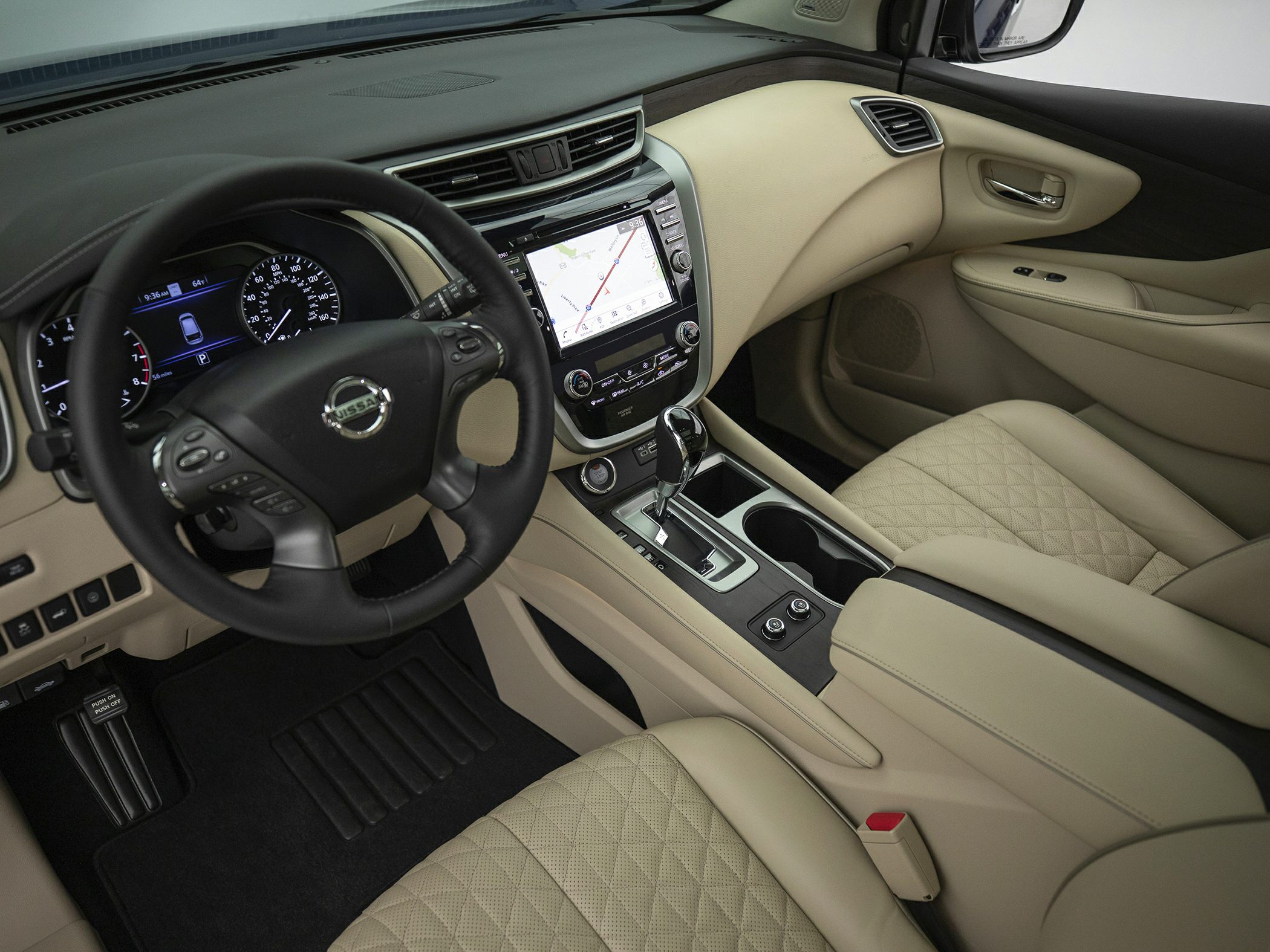 Dashboard with navigation screen, stitched leather seats, and steering wheel