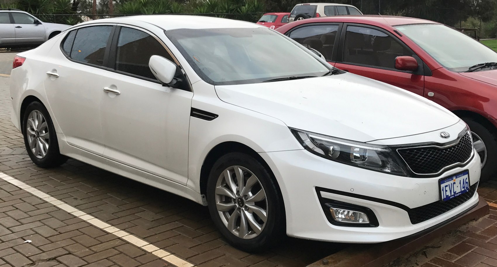 White sedan with front and side view, alloy wheels, and sharp headlights