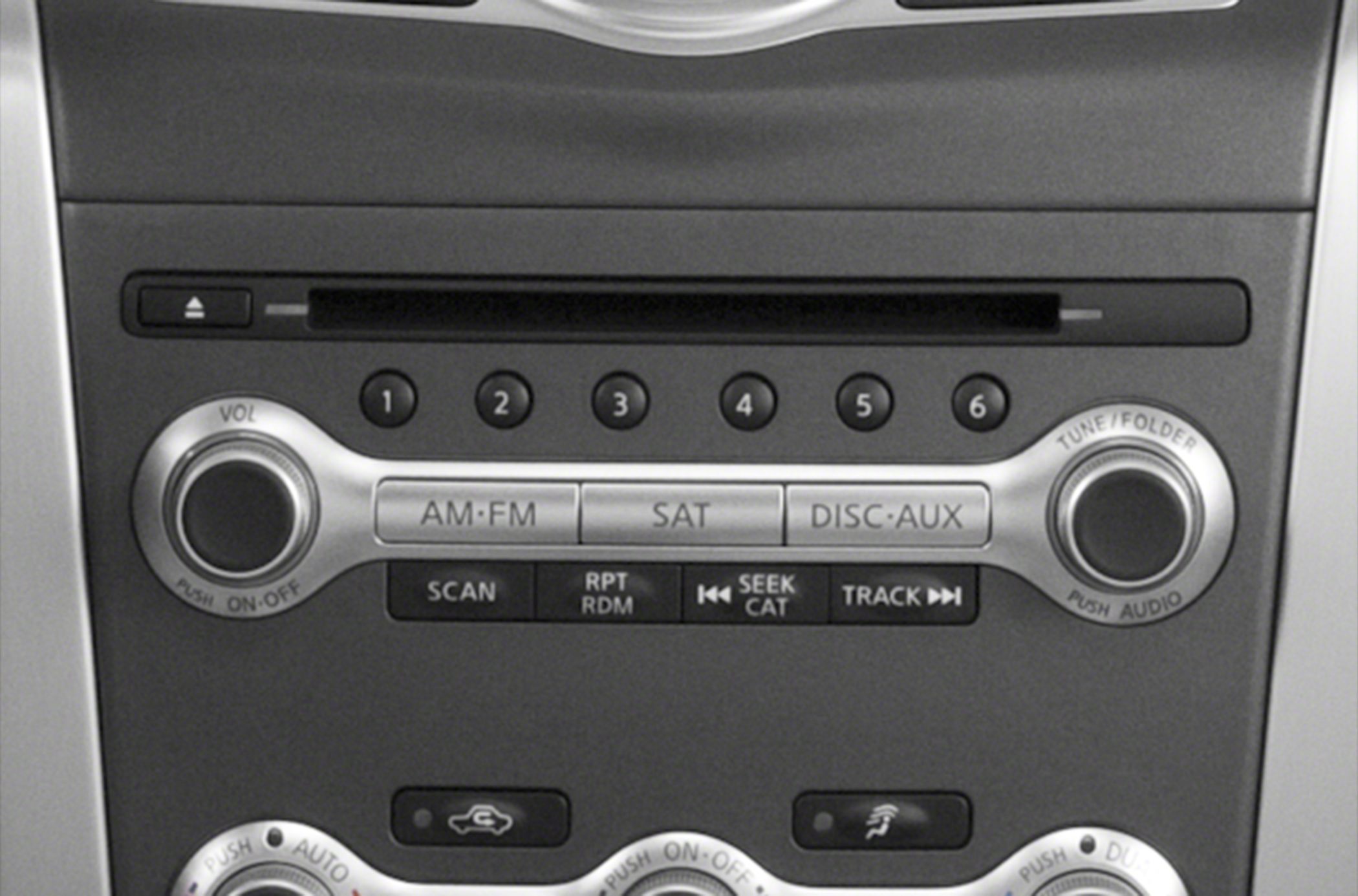 Audio system control panel with volume and tuning knobs, preset buttons.