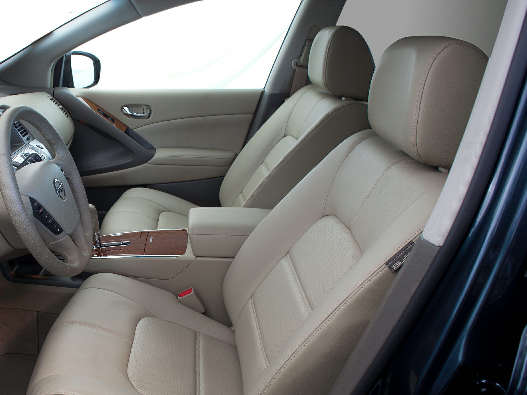 Beige leather seats with wood trim and dashboard interior