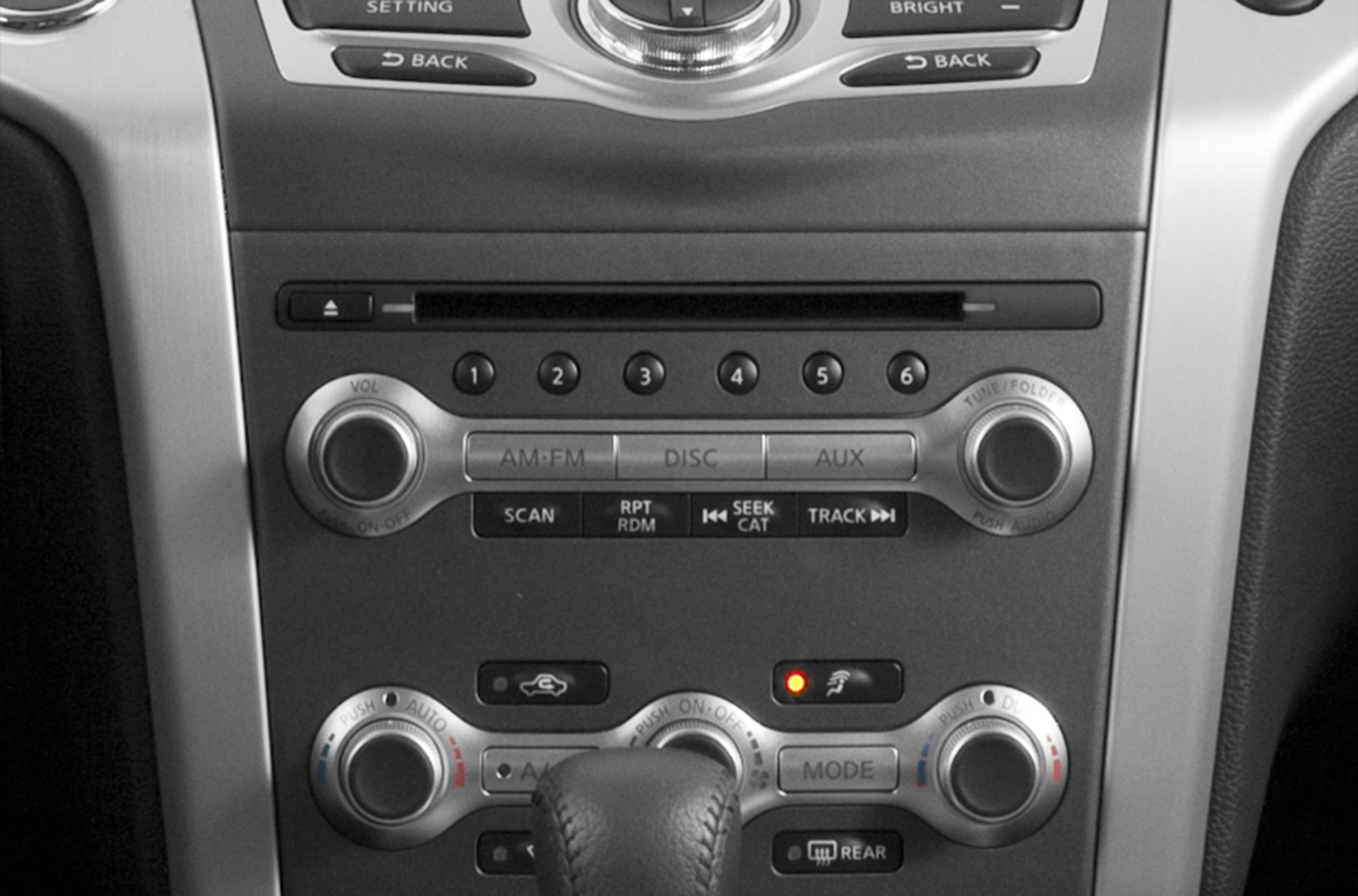 In-dash audio system and dual-zone climate controls with knobs and buttons.