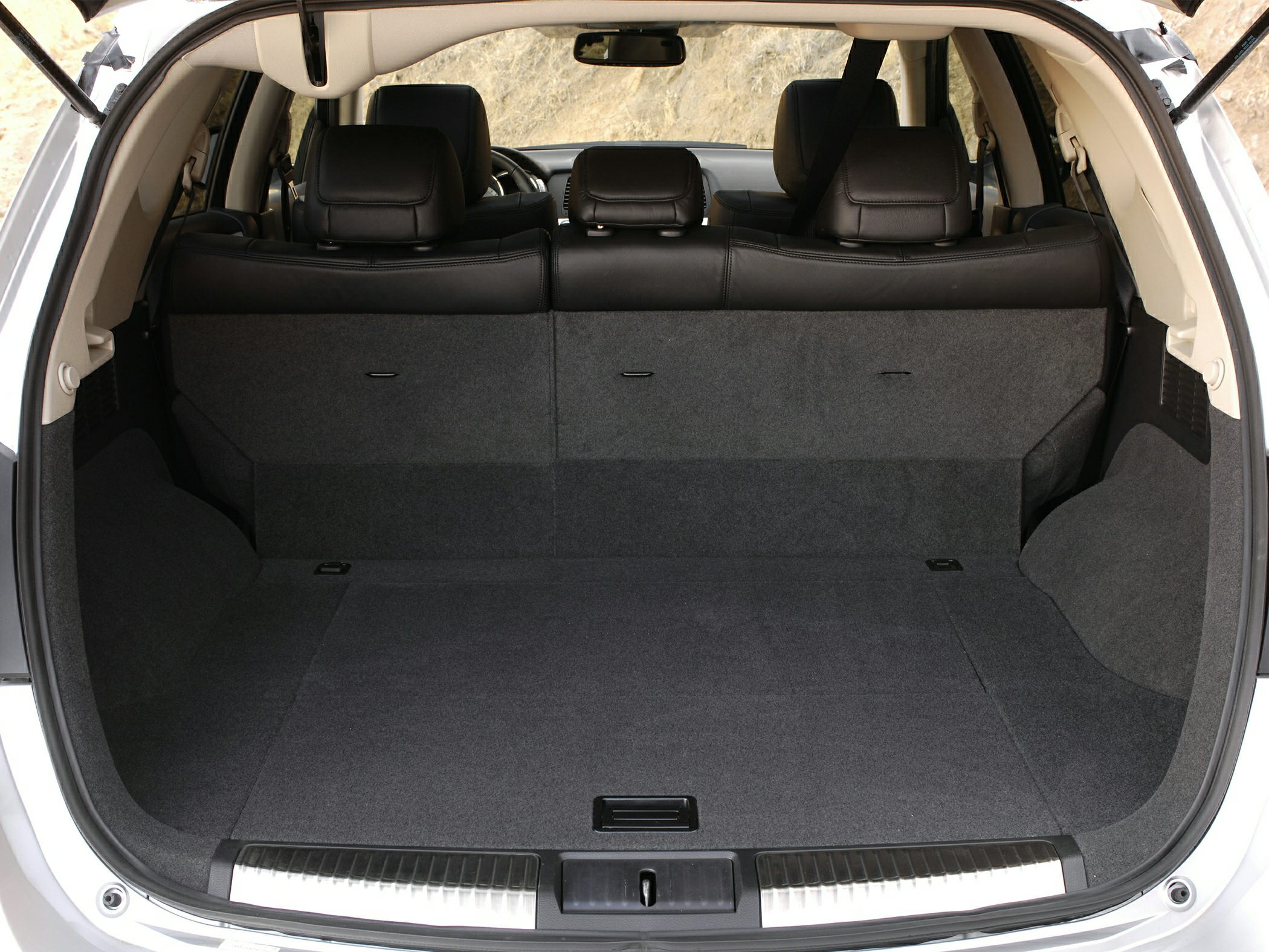 Spacious rear cargo area with foldable rear seats and carpeted lining