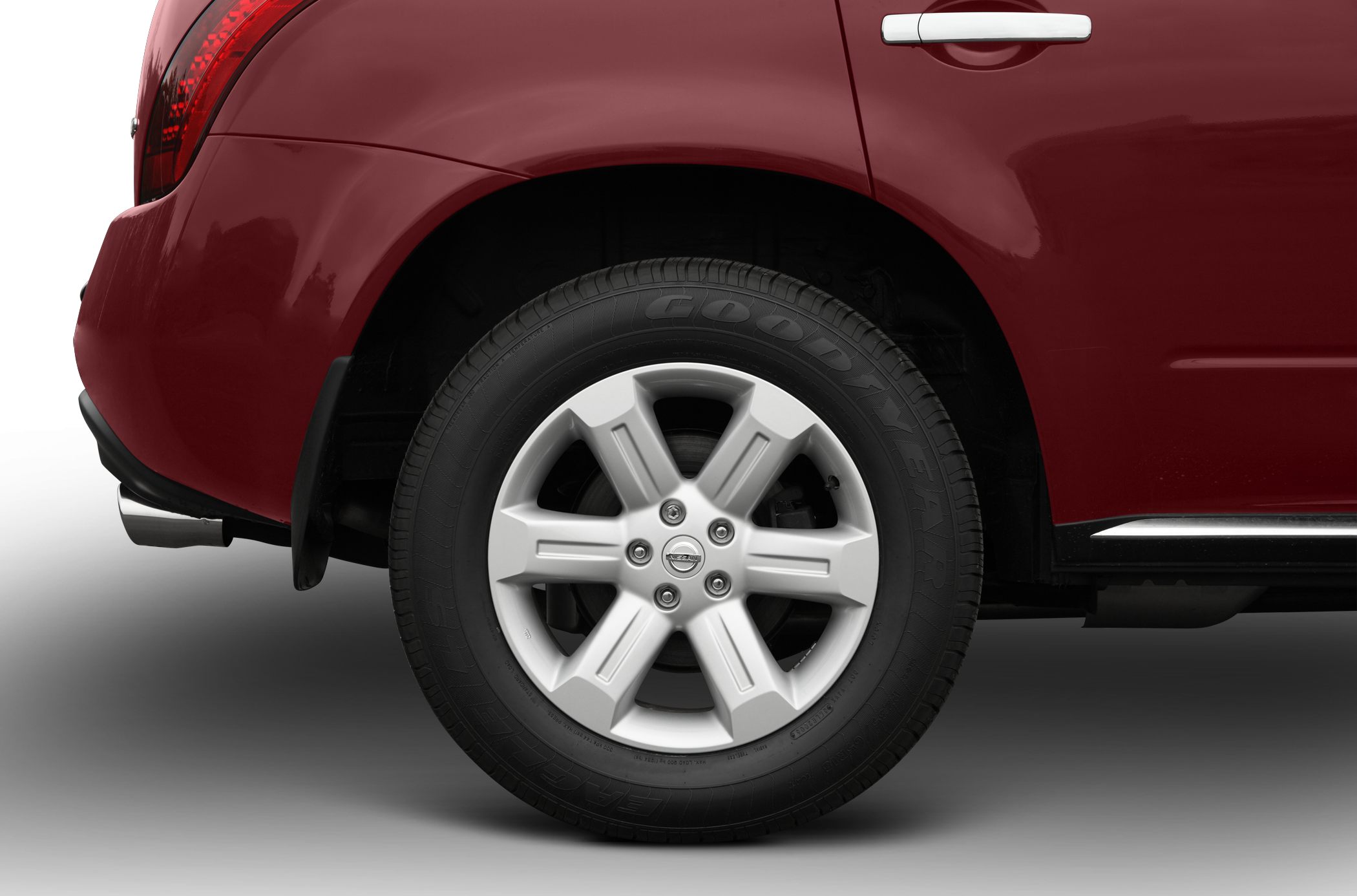 Close-up of rear alloy wheel and tire on red SUV