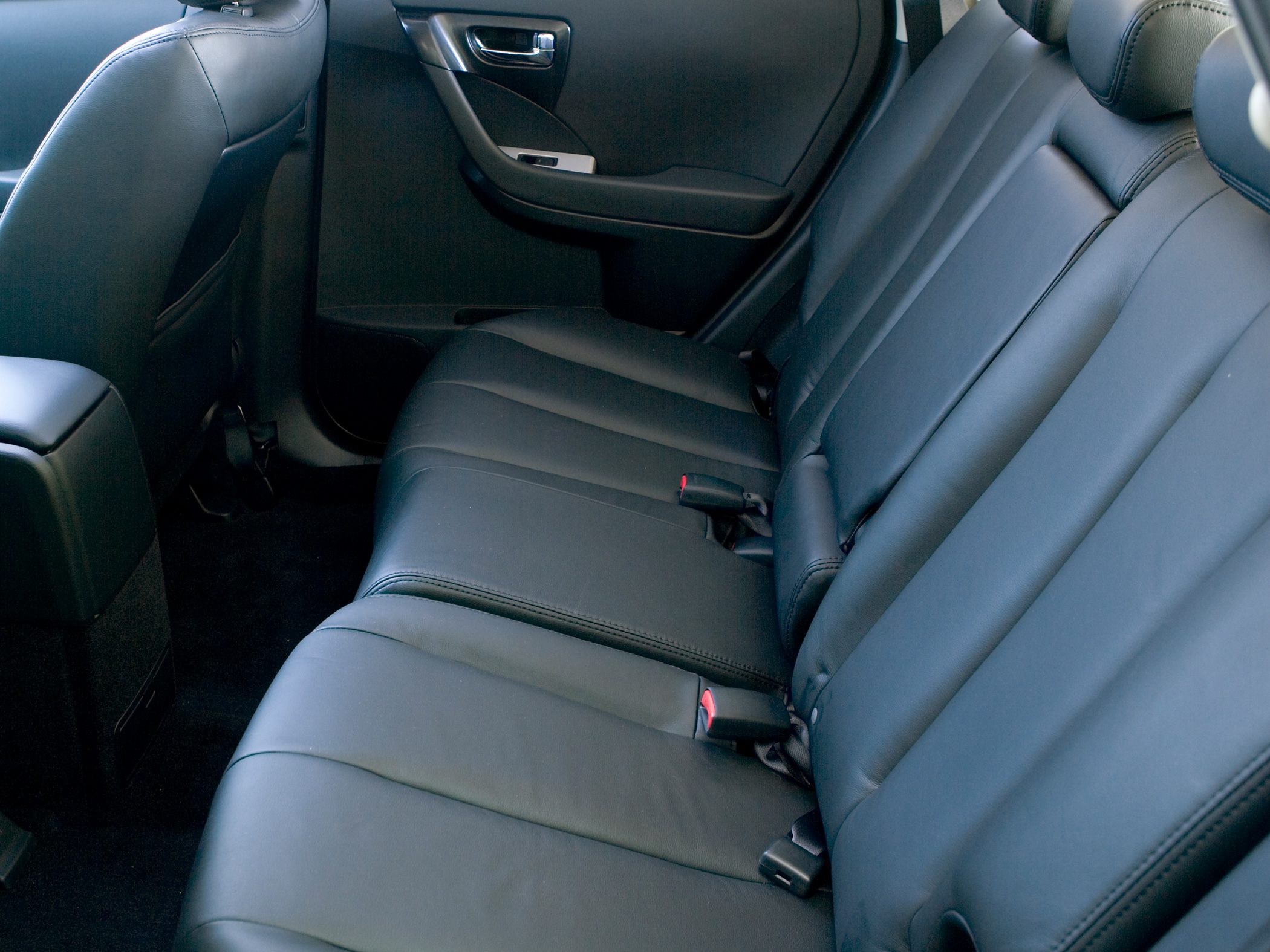 Black leather rear seats with seat belts and door panel