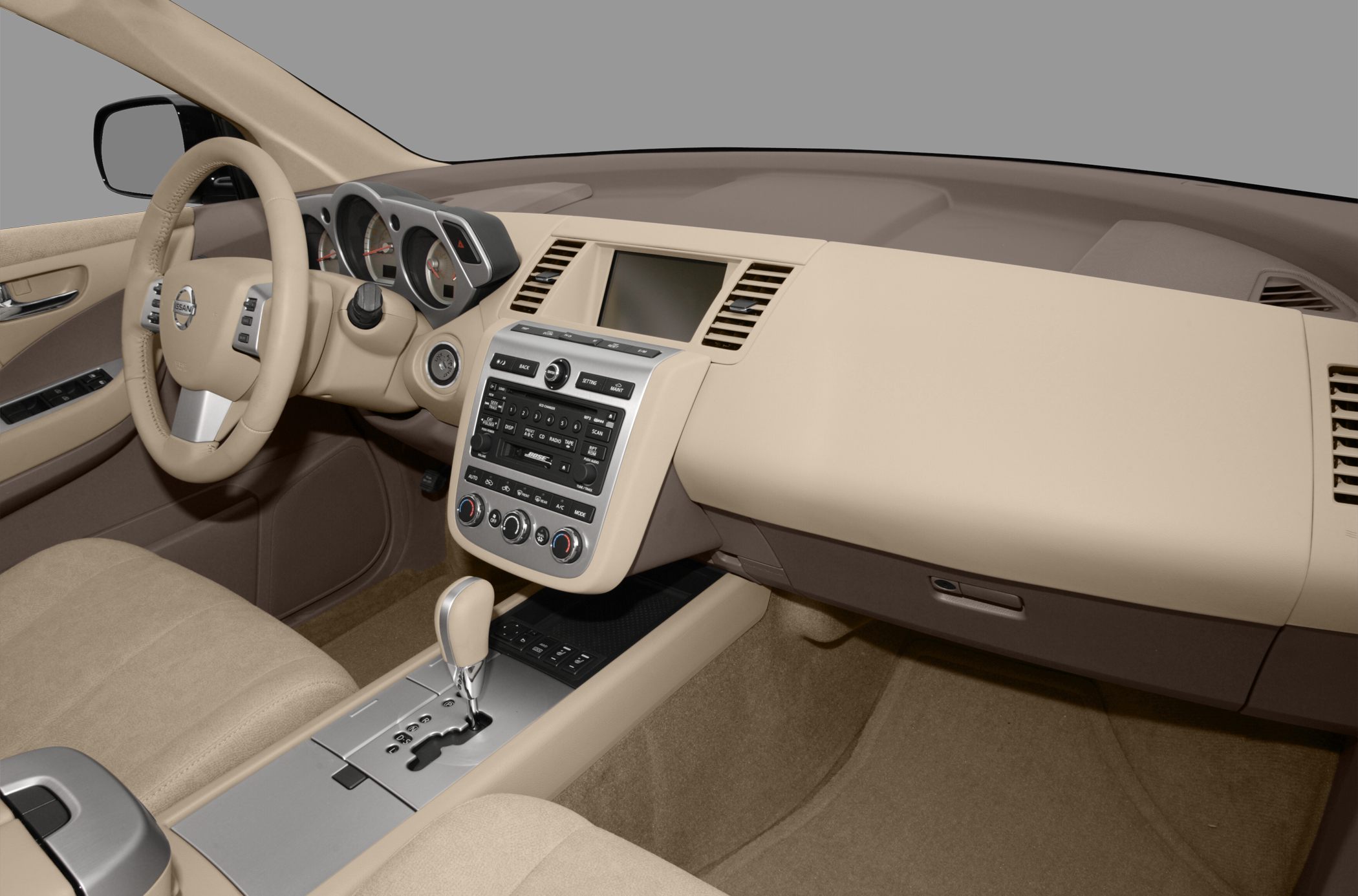 Beige interior dashboard with steering wheel and automatic gear shift