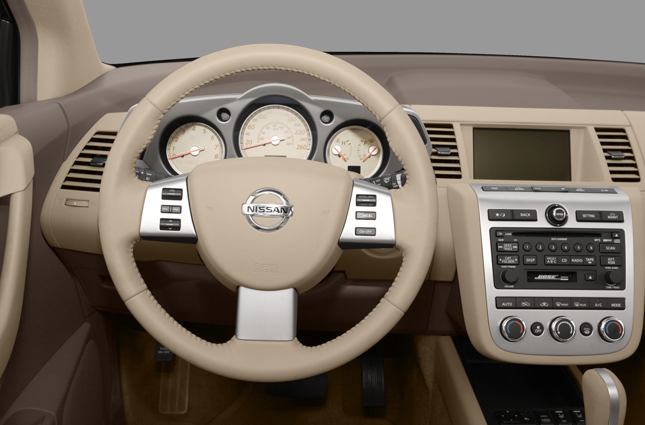 Beige steering wheel and dashboard with instrument cluster and control panel