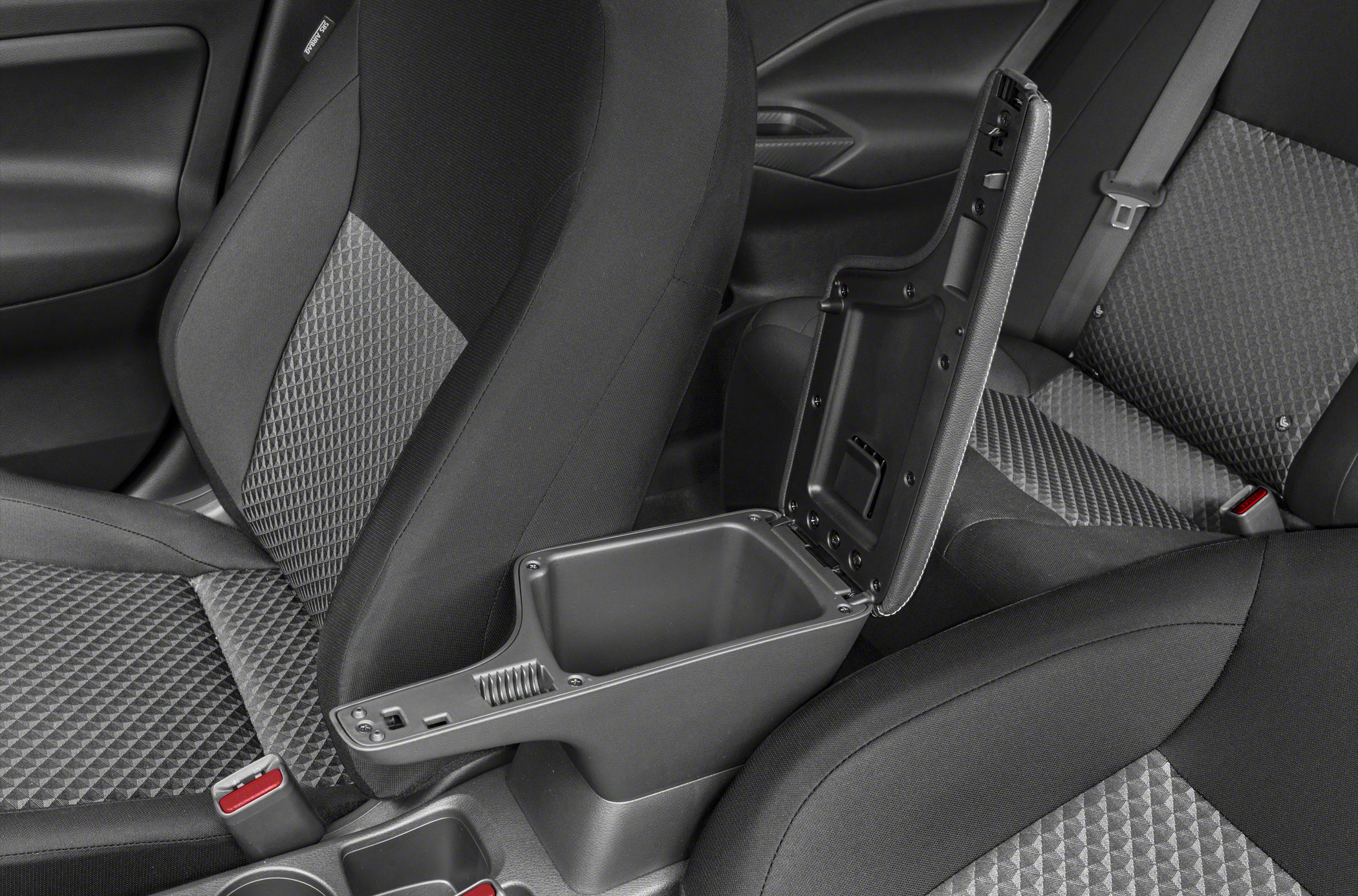 Open center armrest storage compartment with black and gray fabric car seats