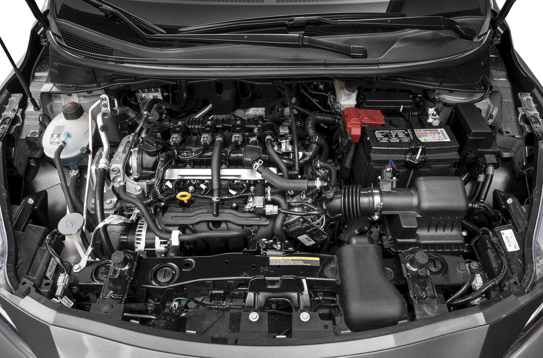 Engine bay with battery, air intake, hoses, and fluid reservoirs