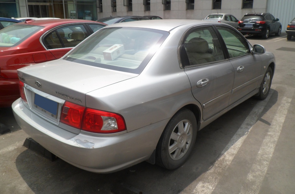 Silver mid-2000s sedan rear with distinctive taillights