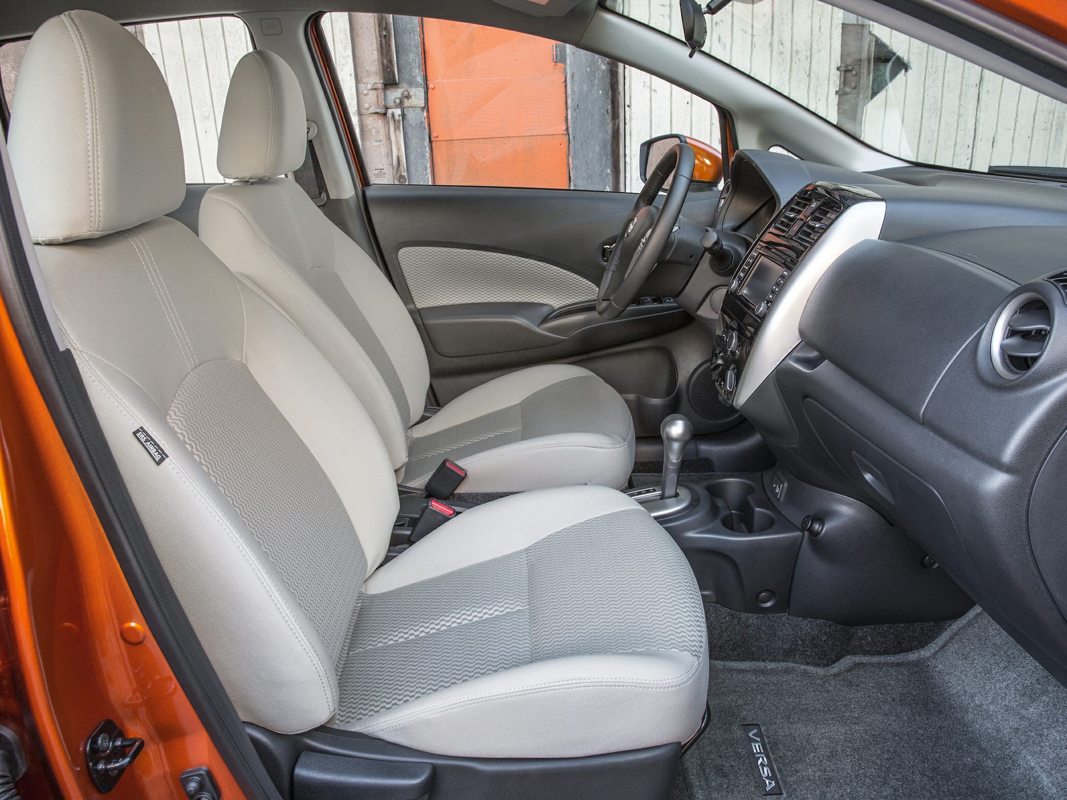 Front seats and dashboard interior with fabric upholstery and gear shifter