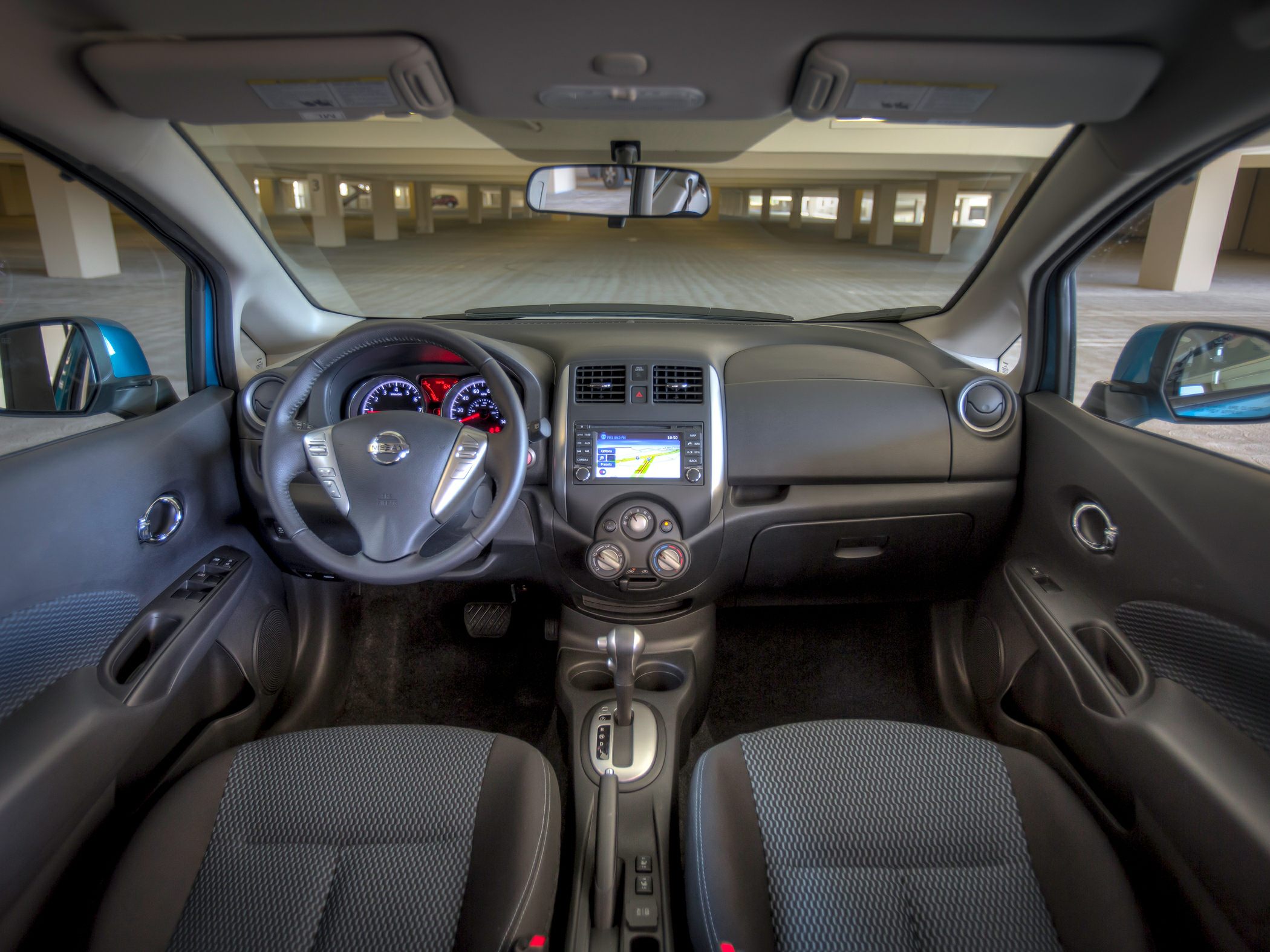 Dashboard with steering wheel, infotainment, and front seats