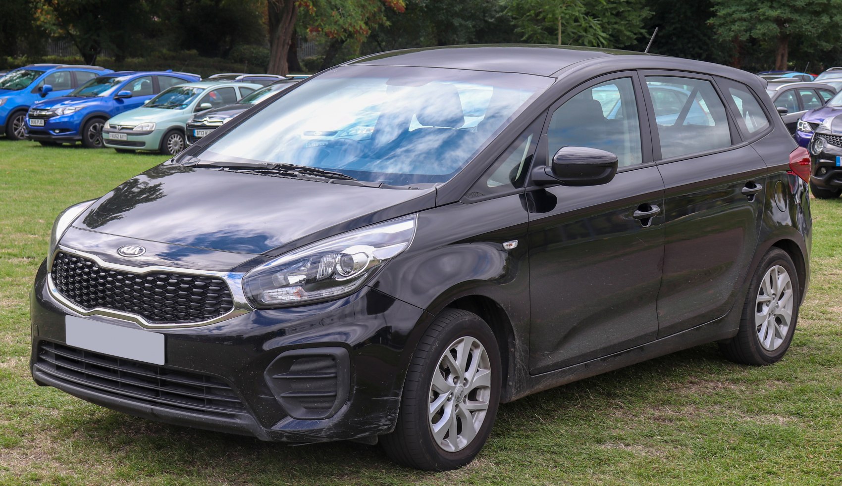 Front 3/4 view of black SUV with distinctive grille and headlights