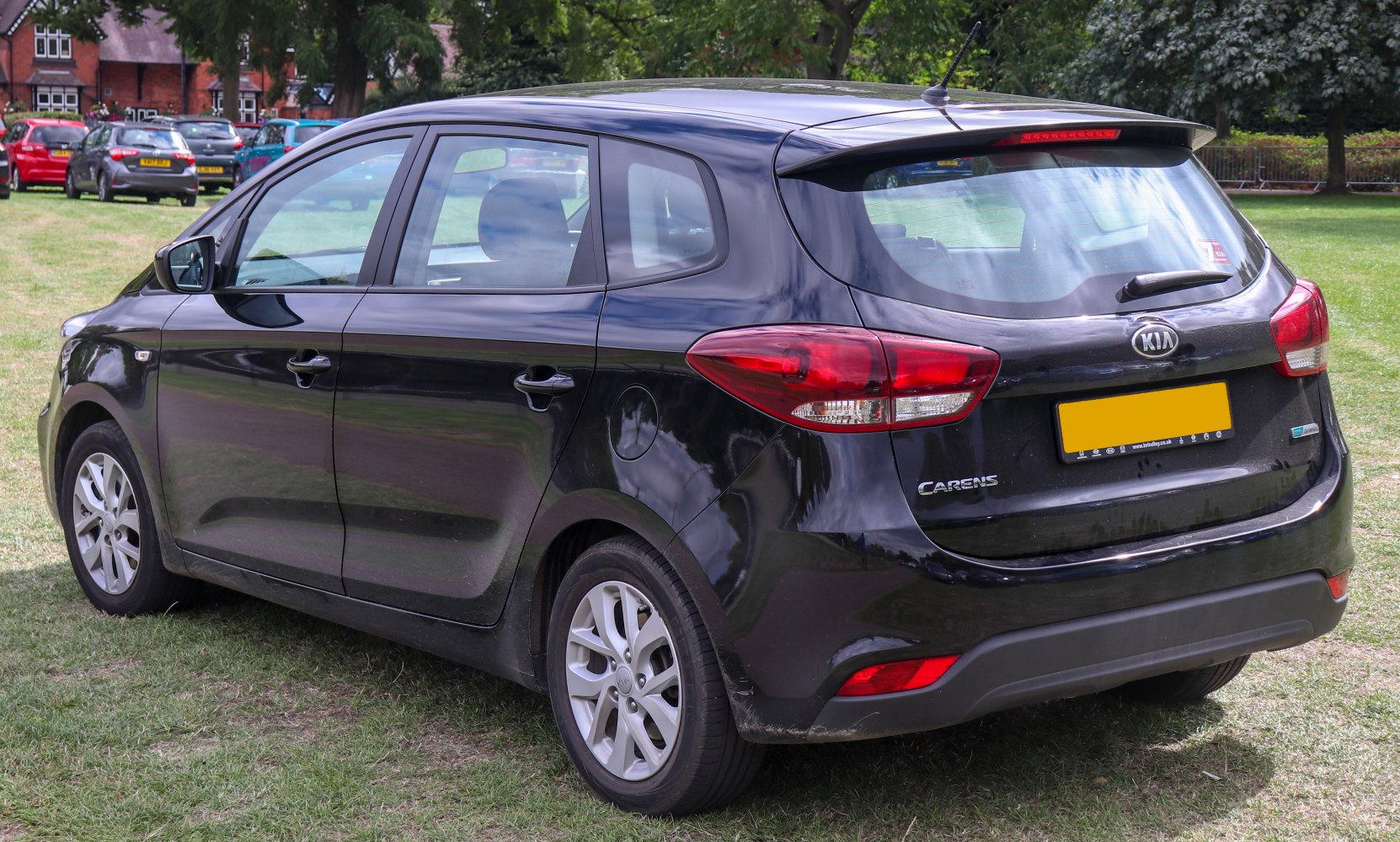 Rear and side view of a black MPV showing taillights and window design