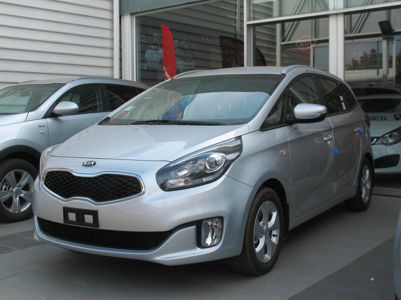 Front and side view with sleek headlamps and distinctive grille