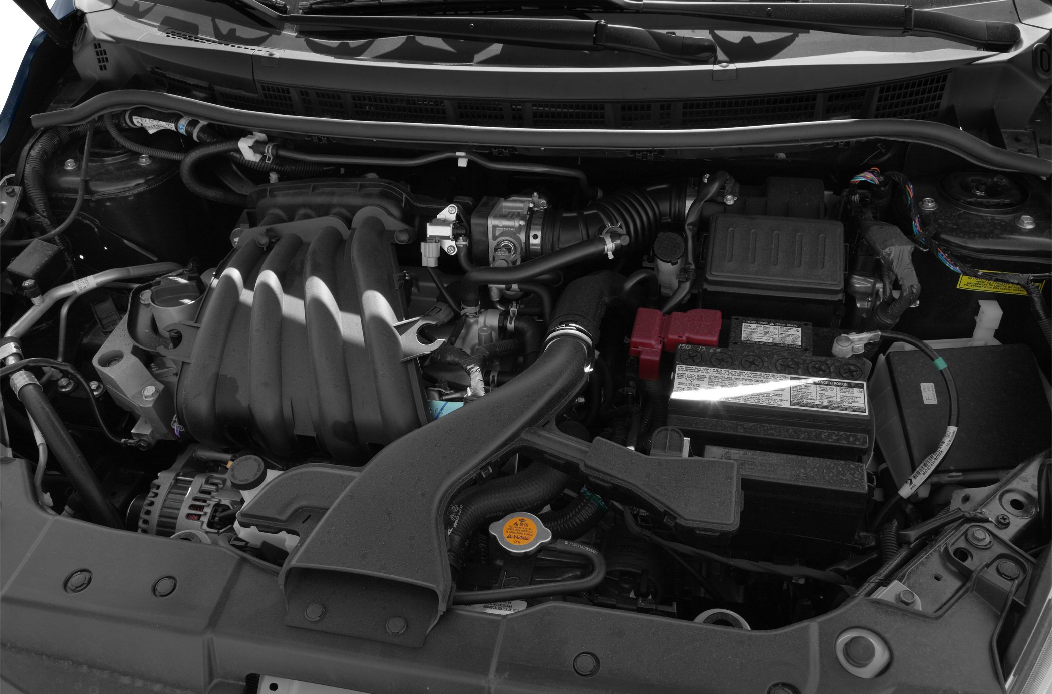 Engine bay with intake manifold and battery components