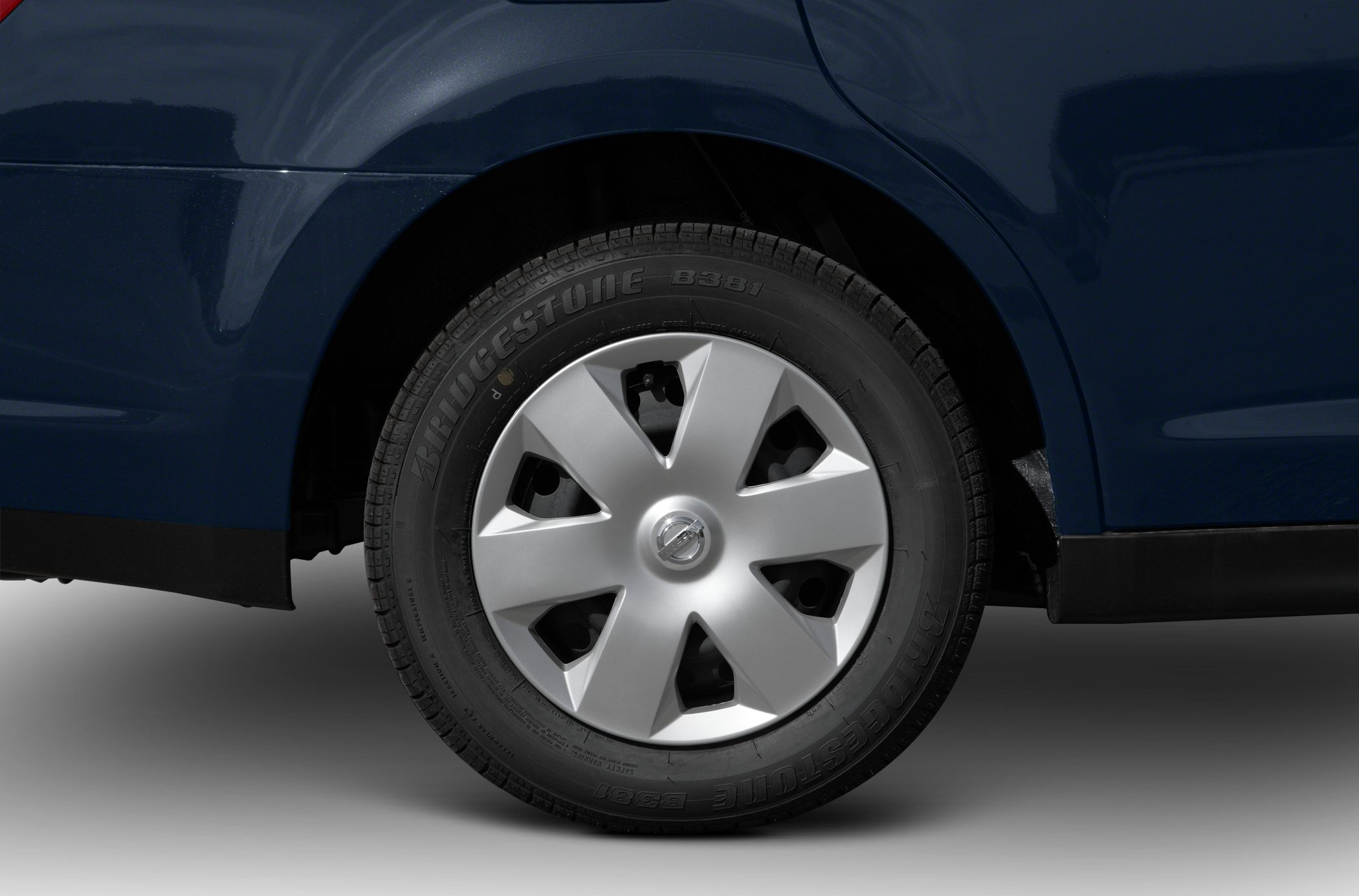Close-up of car wheel with Bridgestone tire and silver wheel cover