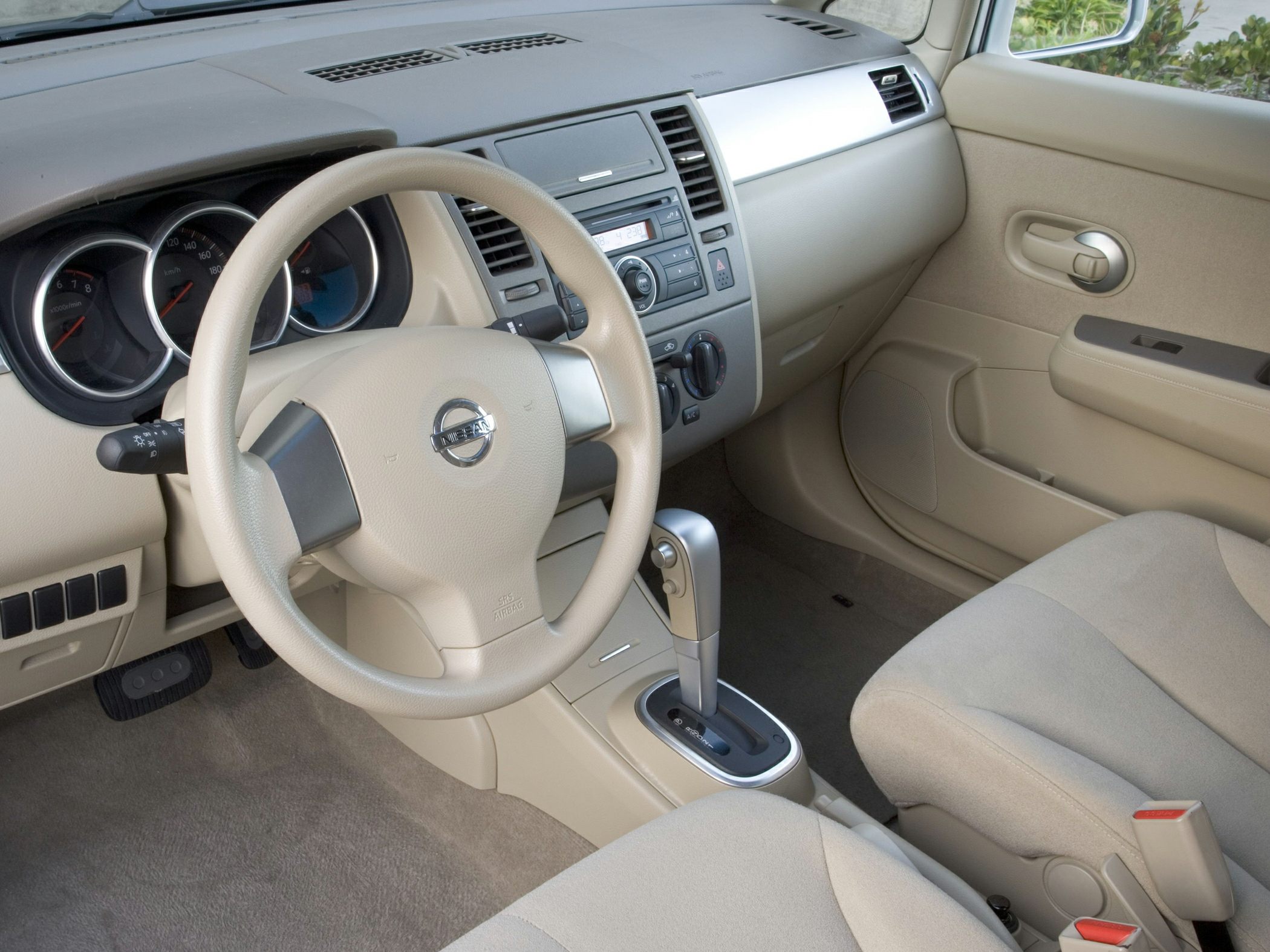 Beige interior with dashboard, steering wheel, and center console.