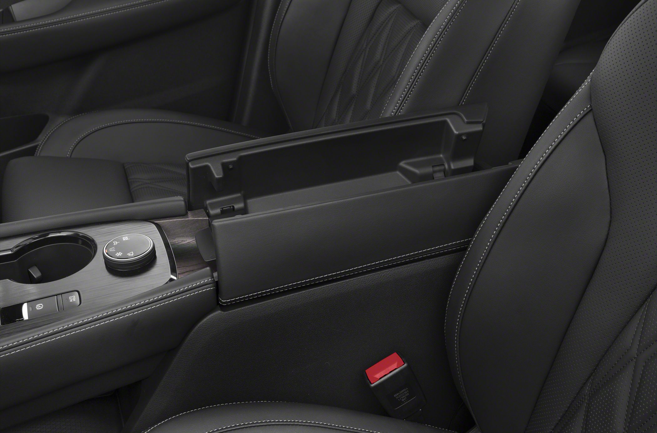 Interior center console and armrest with leather seats featuring detailed stitching