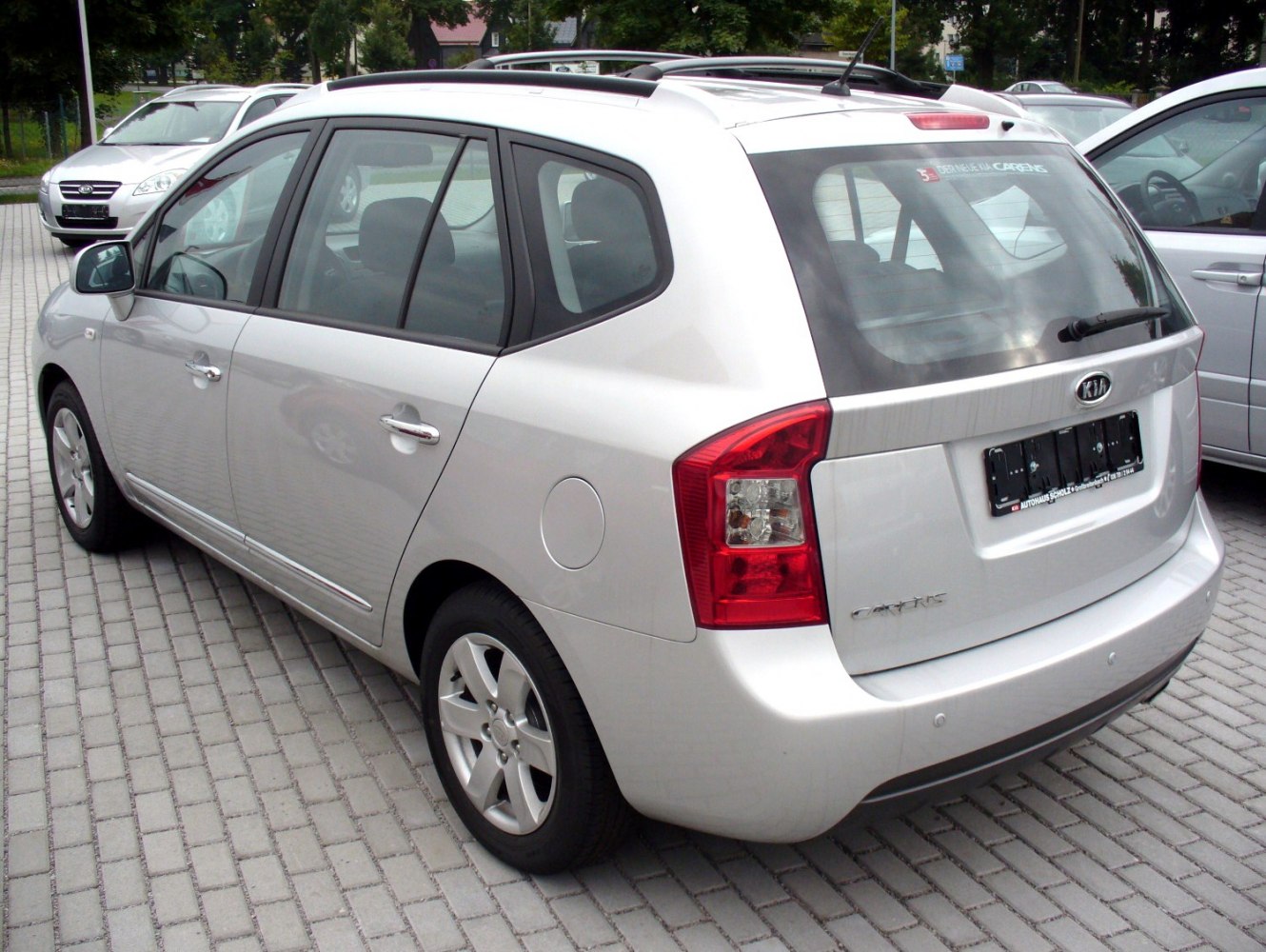 Rear three-quarter MPV view with taillights and alloy wheels