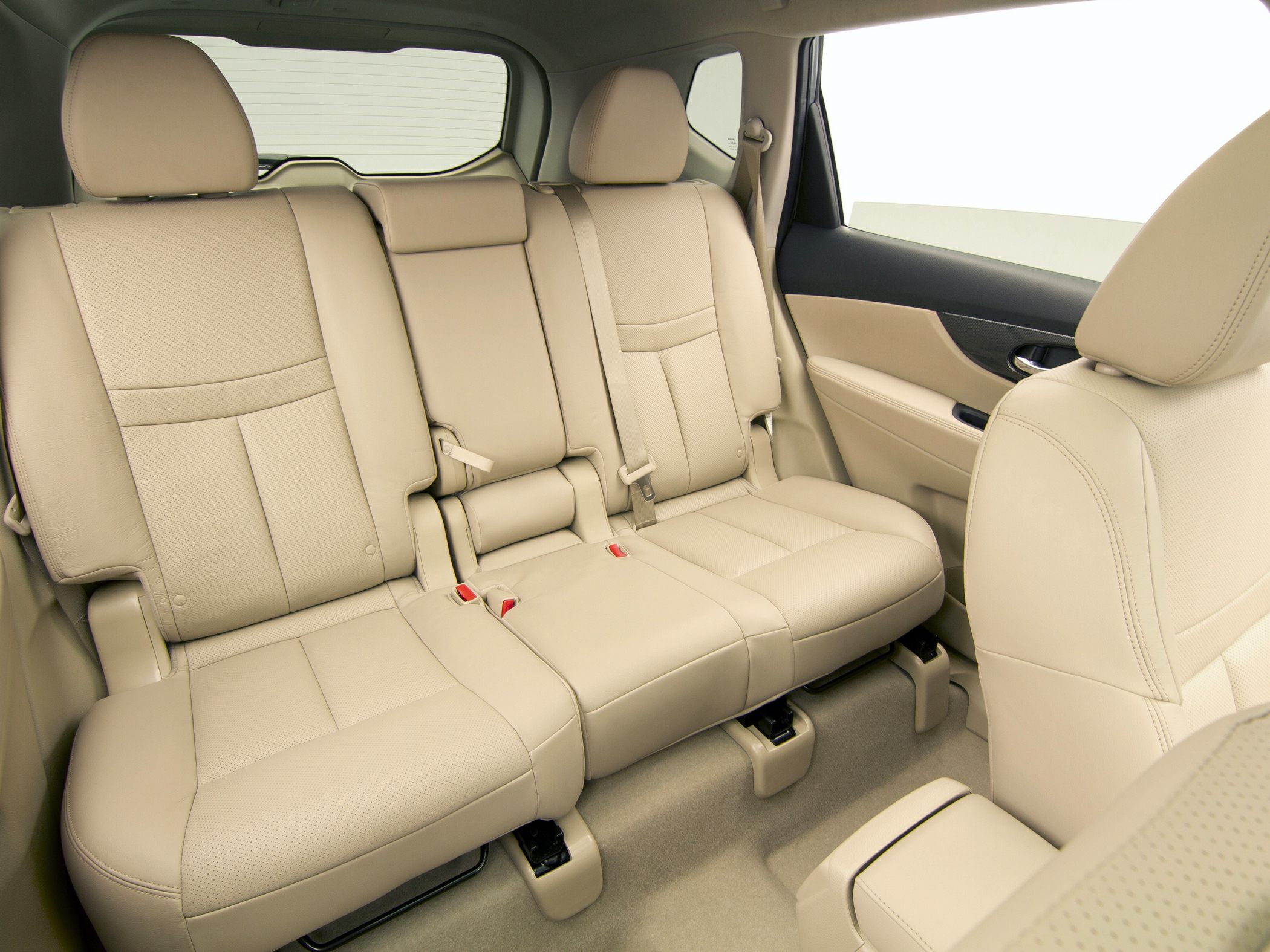 Beige leather rear seats with headrests and seat belts in a mid-sized SUV.