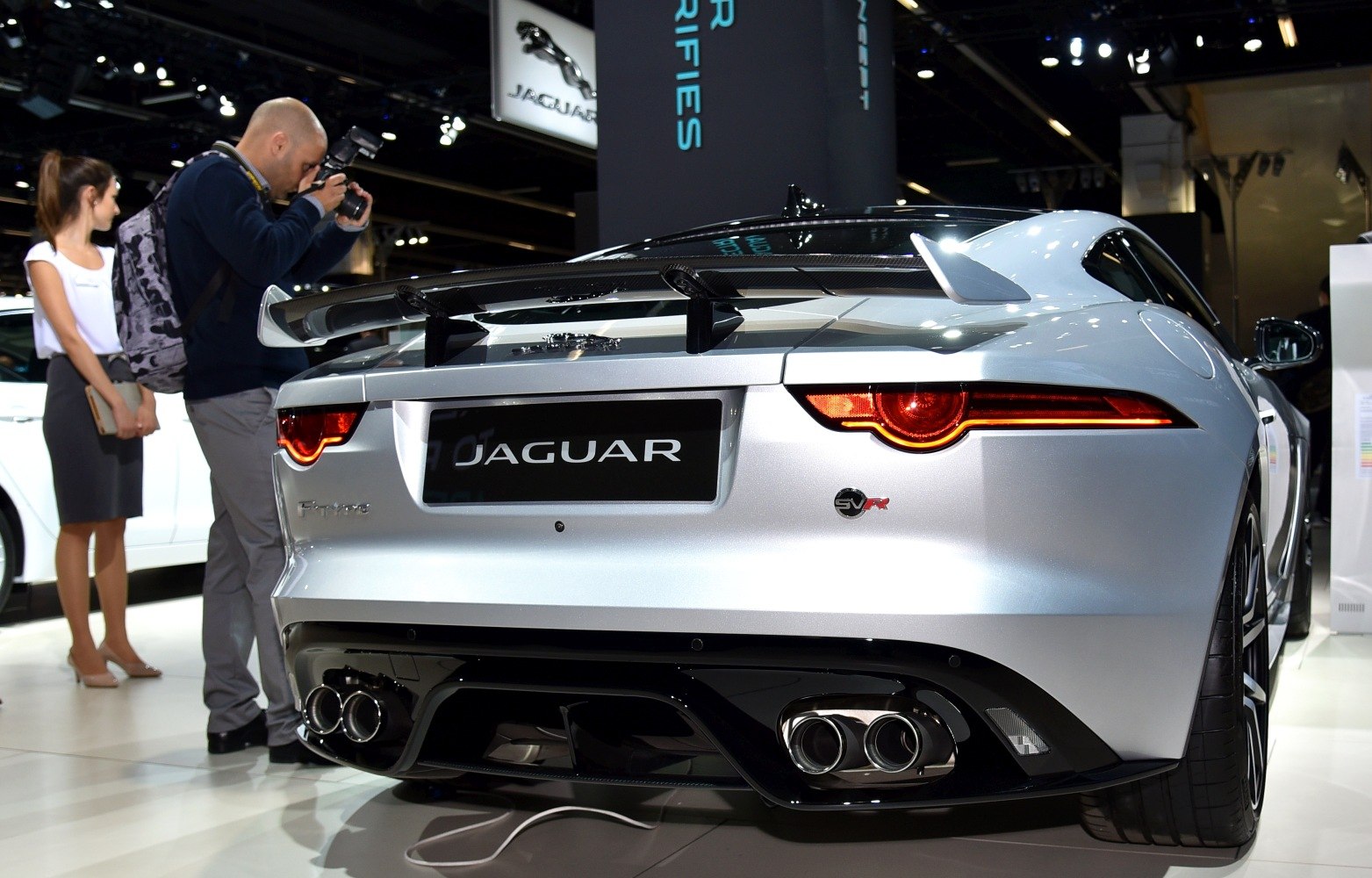 Rear view of sports coupe with carbon spoiler and quad exhaust tips