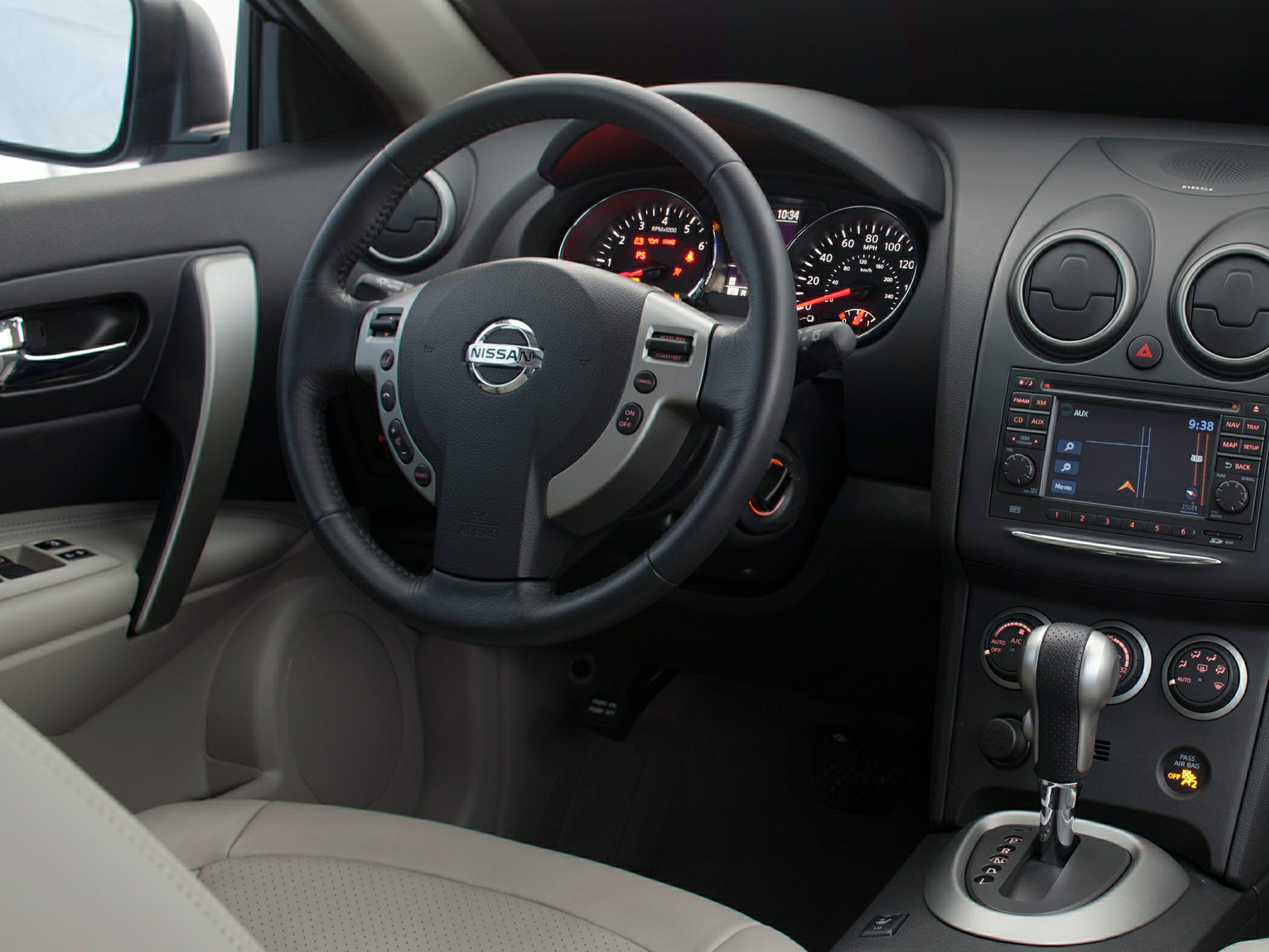Dashboard, steering wheel with controls, center console with gear shifter and infotainment