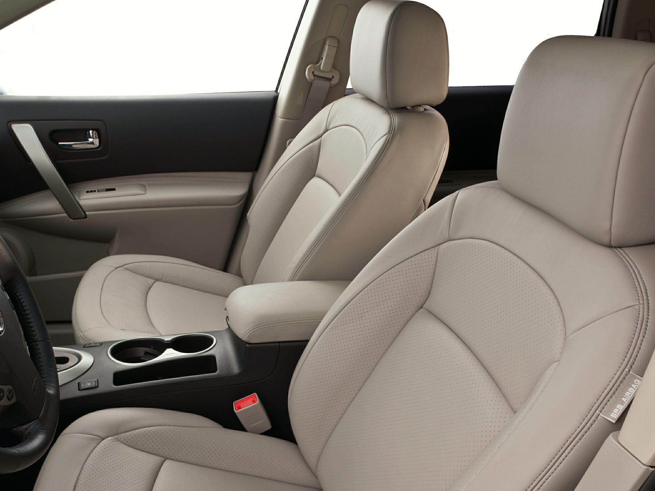 Beige leather front seats with center console and armrest.