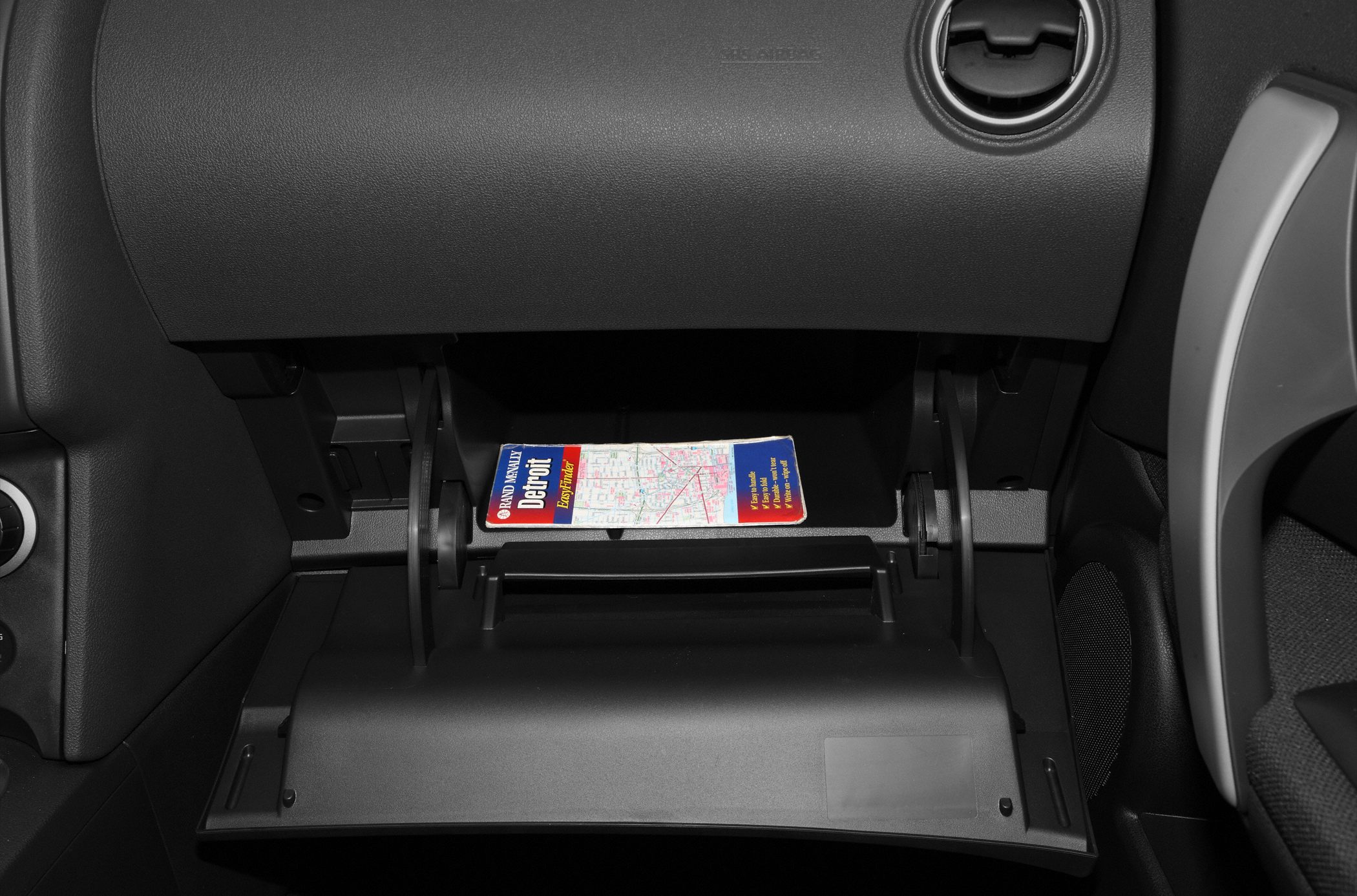 Glove compartment with usable storage space and a map inside