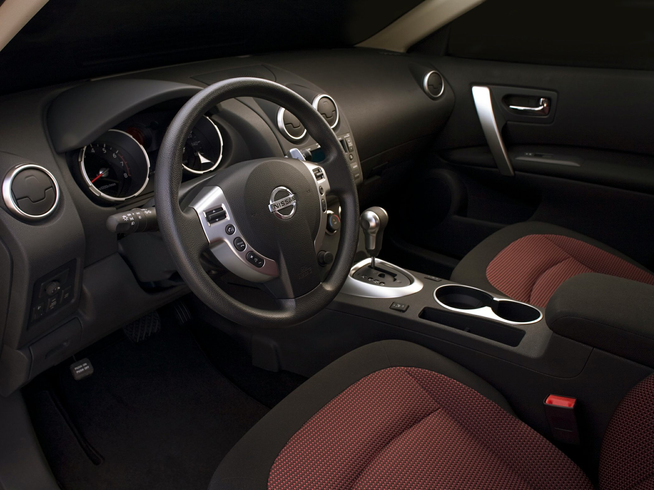 Steering wheel and gear shift with red fabric front seats