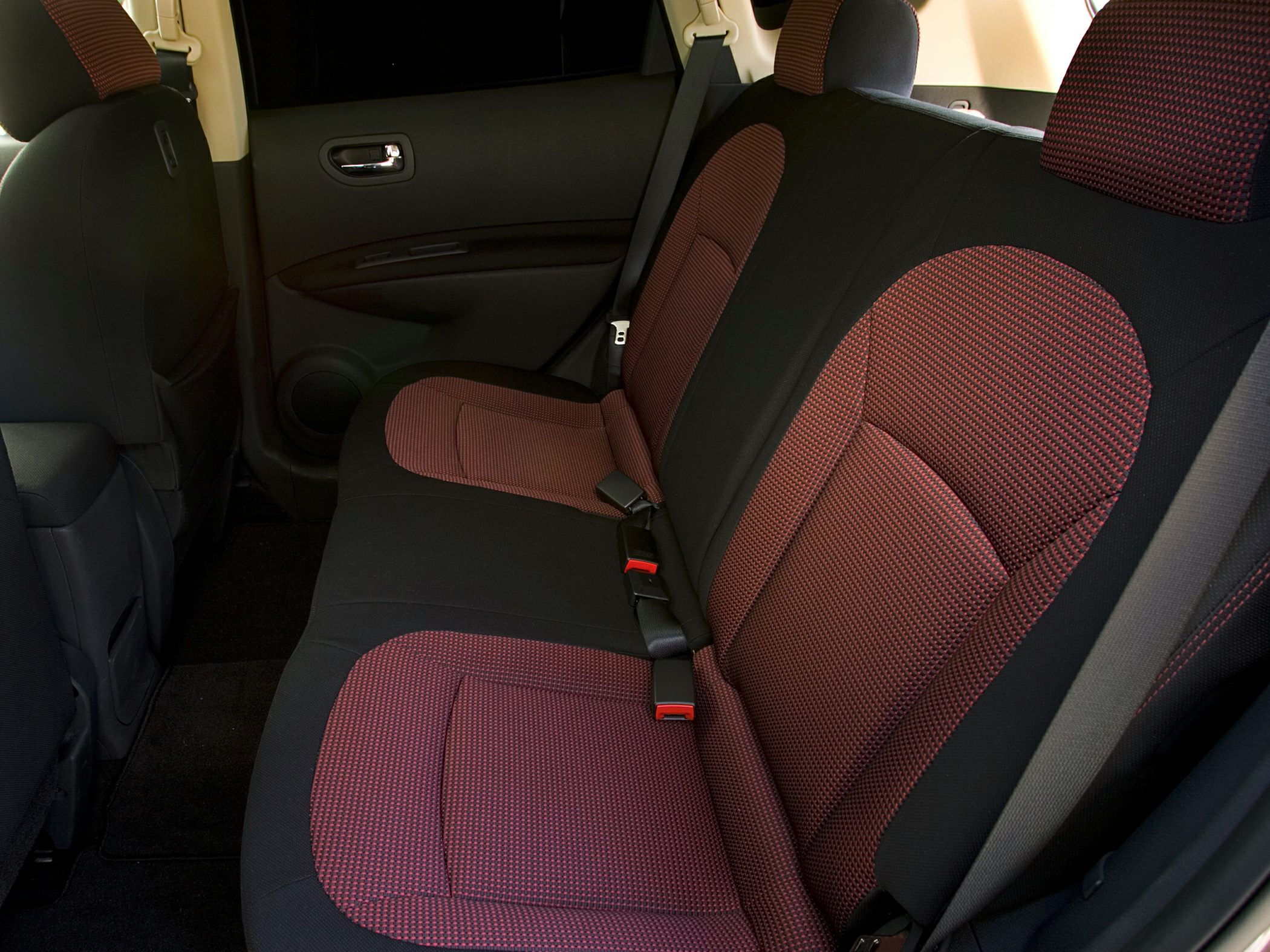 Rear seats fabric upholstery with seat belts in car interior