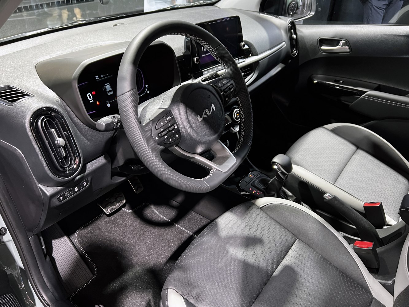Multifunction steering wheel and dual digital displays inside a modern car interior