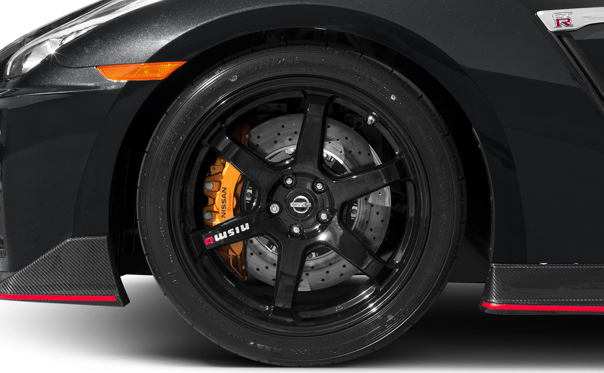 Close-up of black alloy wheel with performance brake system and orange calipers