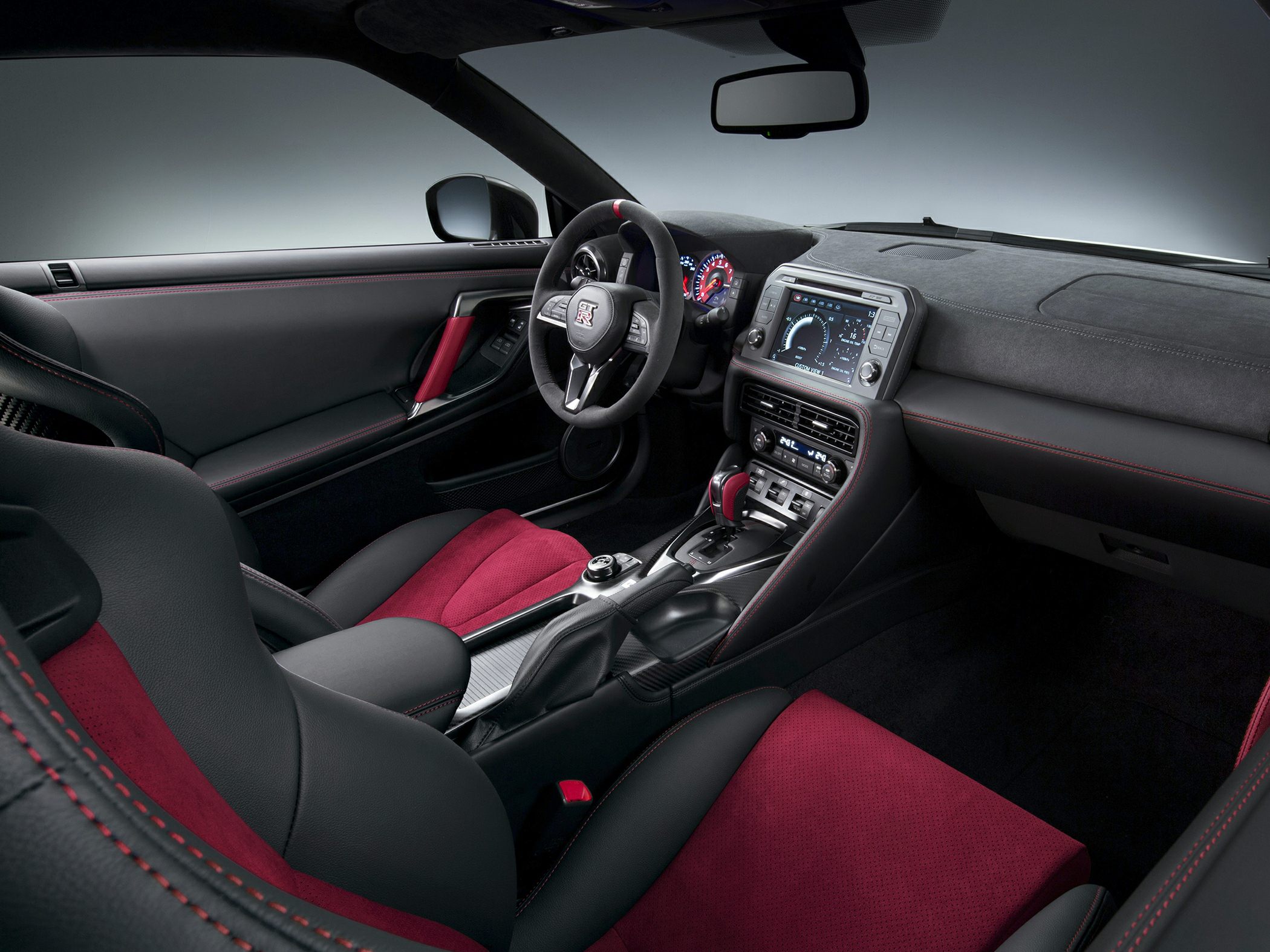 Sporty red and black interior with digital dashboard and premium seats