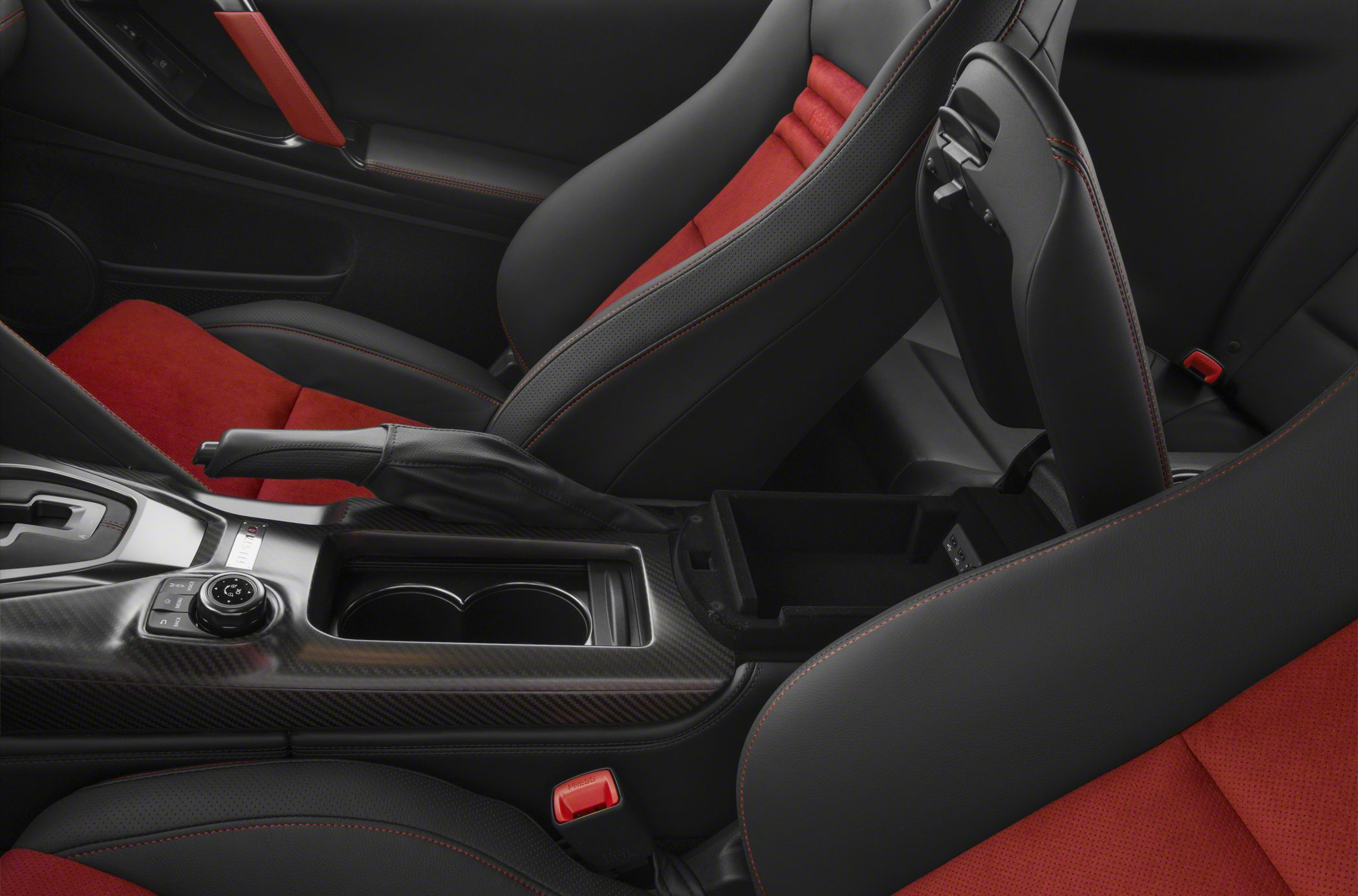 Red and black sport seats with carbon fiber center console and handbrake.