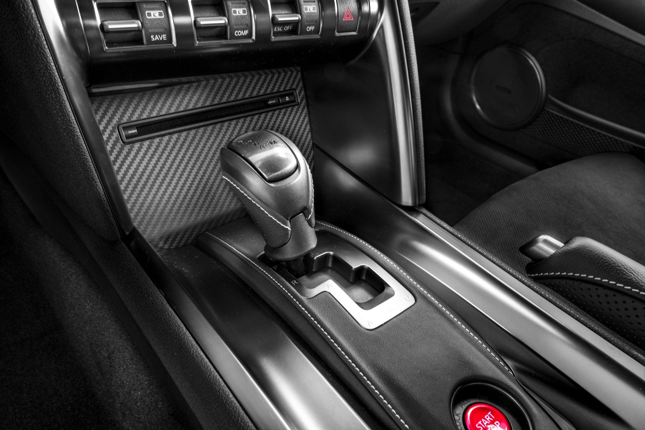 Gear shifter and control buttons in a high-performance car interior