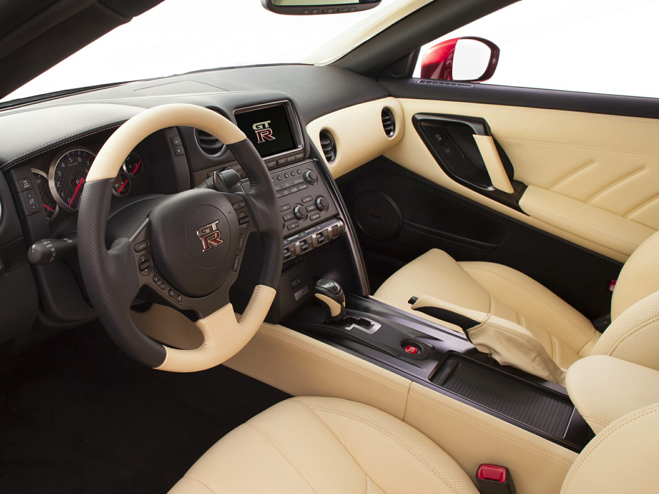 Dual-tone GT-R branded steering wheel and beige leather sport seats