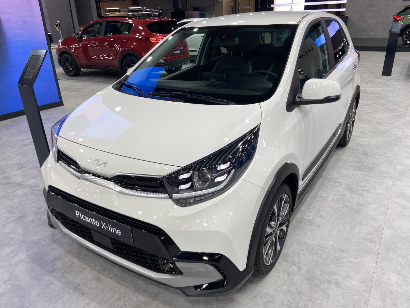 White hatchback with modern headlights and distinct grille.