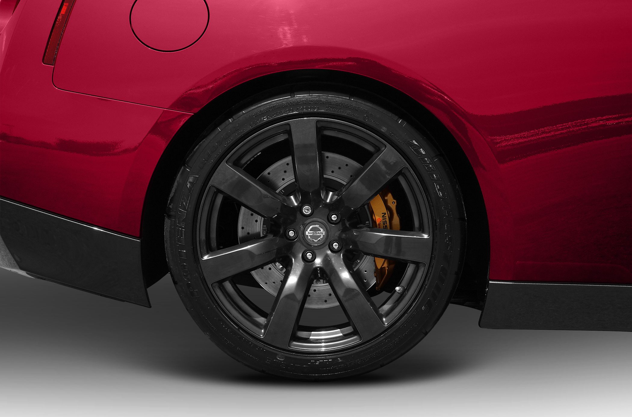 Black alloy wheel with yellow brake caliper on red body