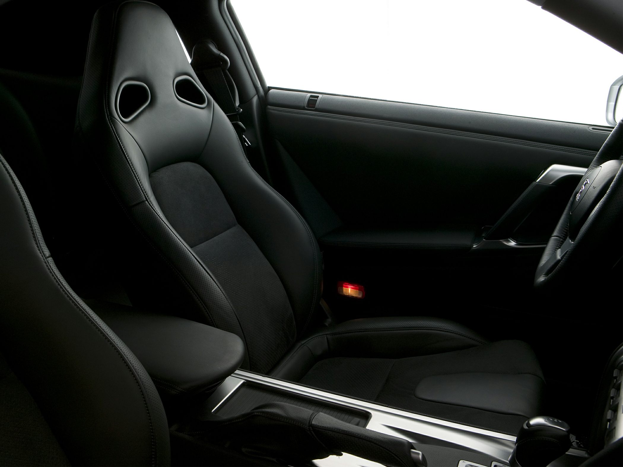 Sporty black leather bucket seat and center console in car interior