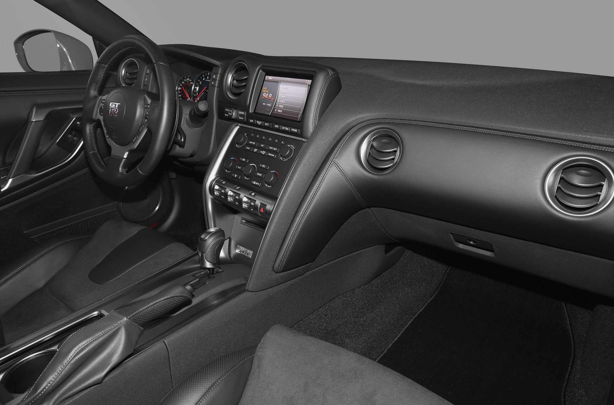 Interior dashboard and center console with steering wheel and multimedia display.