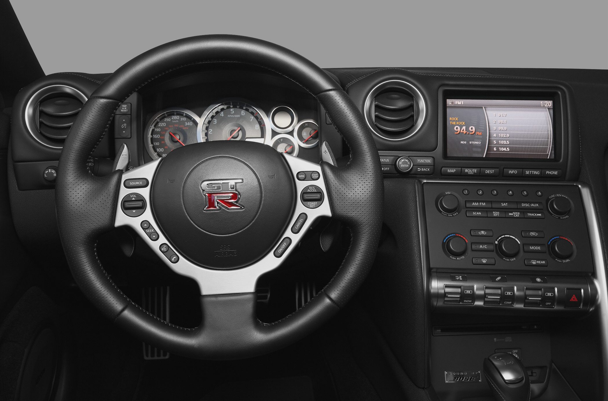 Sporty steering wheel and dashboard controls of a performance car interior