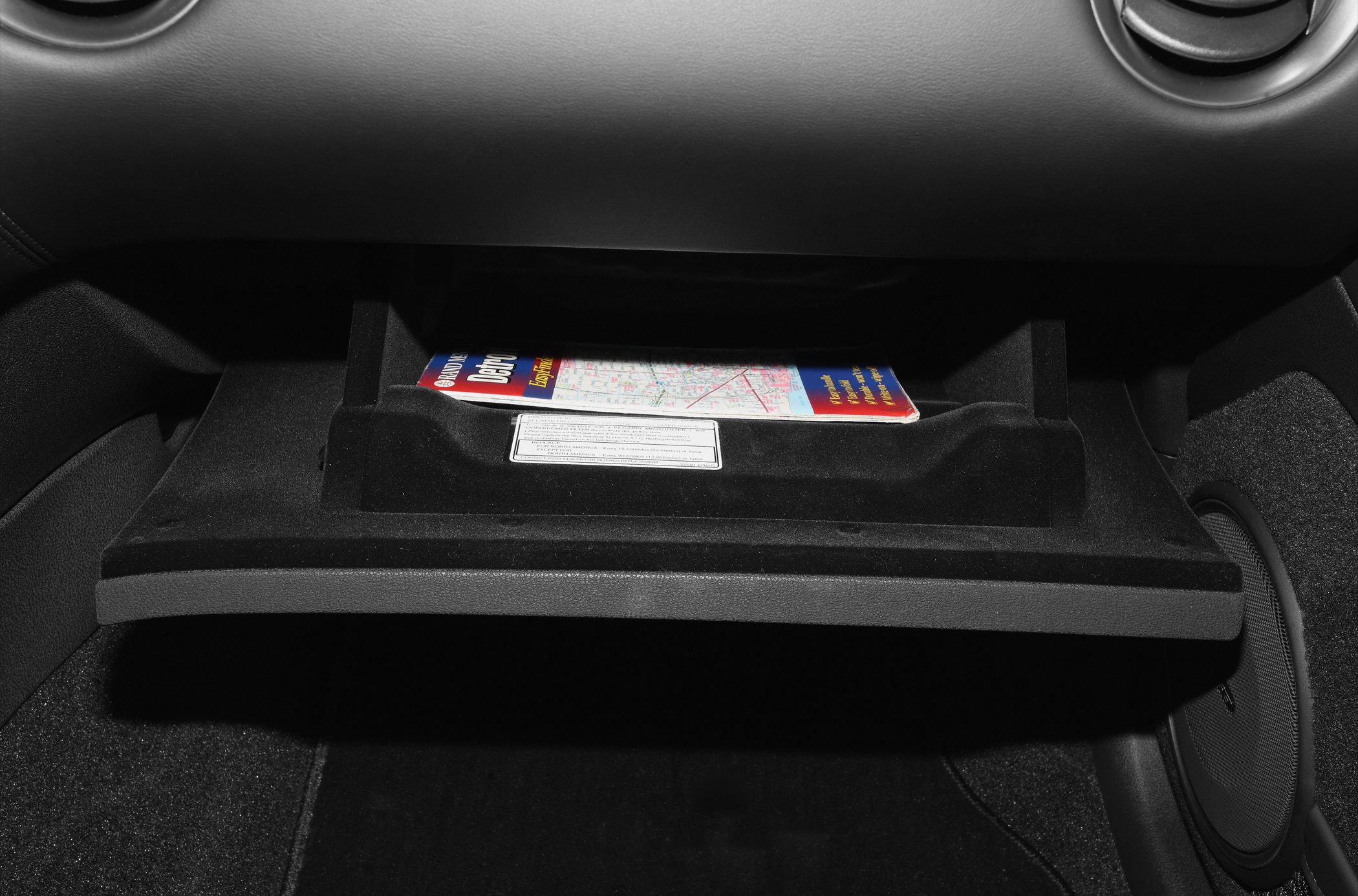 Glove compartment storage with map inside car interior